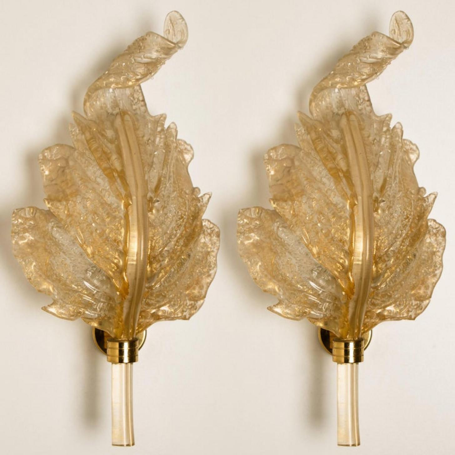 Pair of elegant and exquisite hand blown murano glass Barovier & Toso wall sconces with special gold inclusions. Each light fixture consists one blown murano glass leave. Mounted on a brass frame. The leaves refract light beautifully. The flush