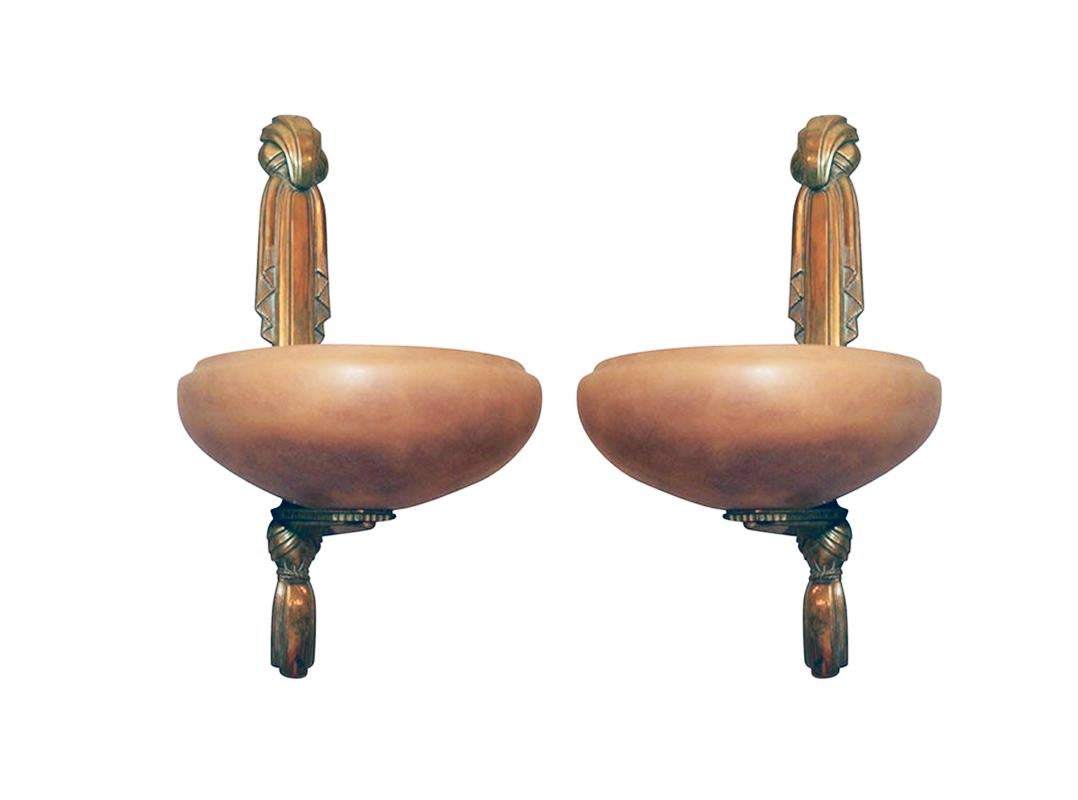 A pair of Art Deco alabaster and gilded bronze wall sconces by Sue et Mare from 1930s. A similar model illustrated in 