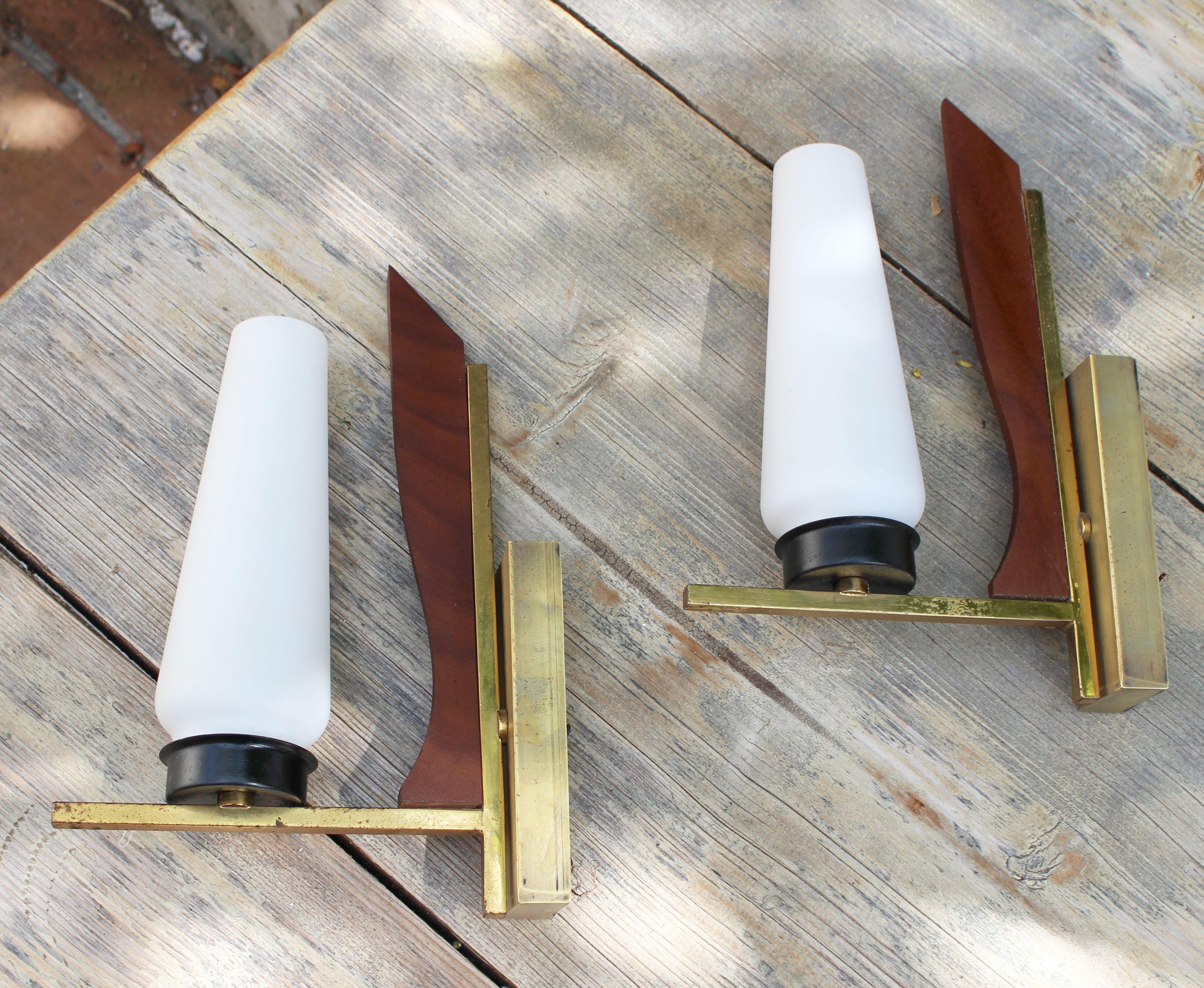 Italian wall lights, mid century brass and wood base with the white glass shades.

 