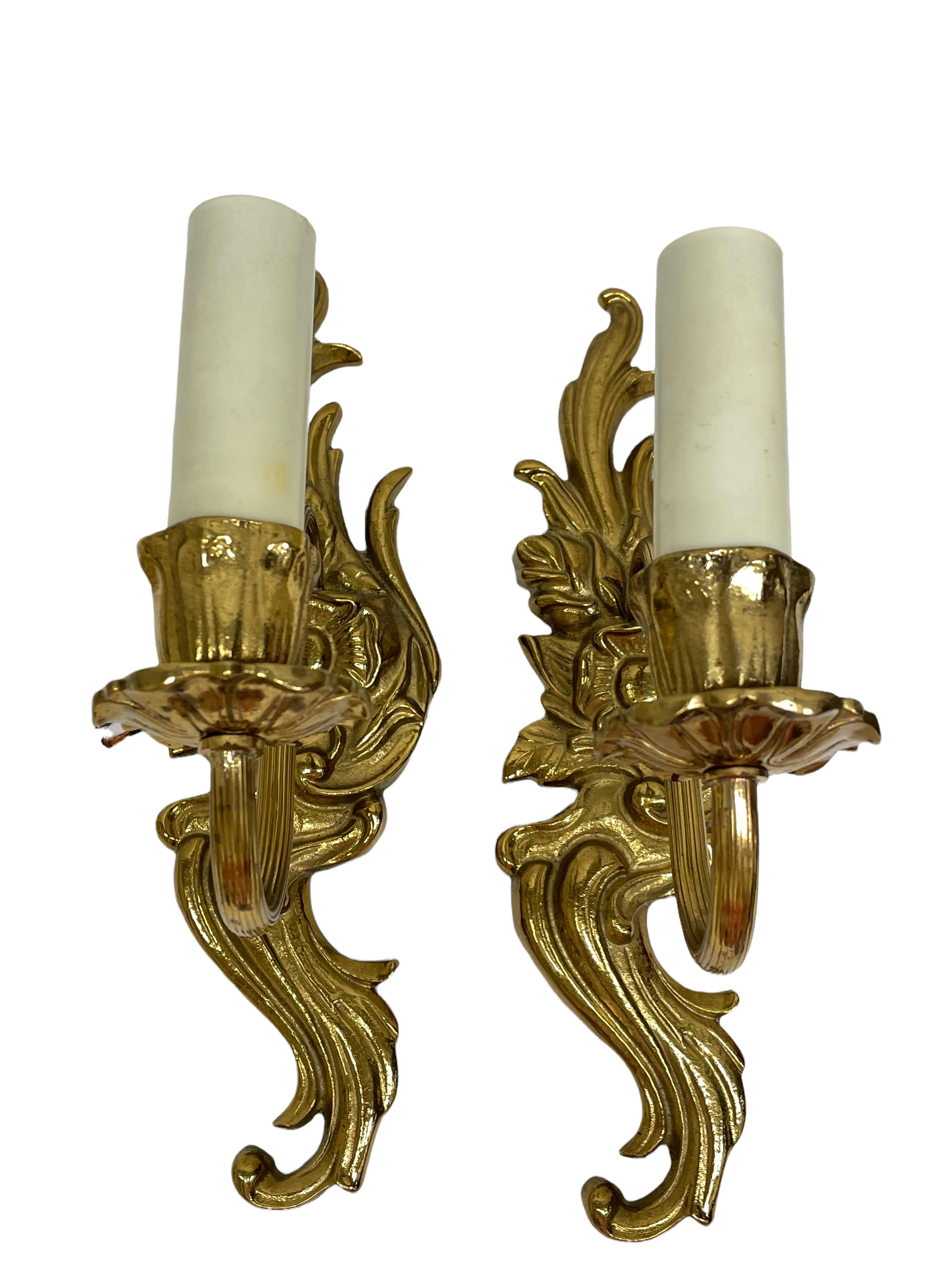 Pair of nice sconces. Each fixture requires a European E14 candelabra bulb, bulb up to 40 watts. Each wall light has a beautiful patina and gives each room an eclectic statement. Made of bronze metal. Nice addition to any room. Found at an Estate