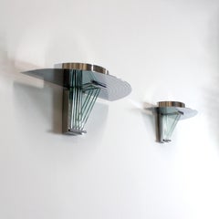 Pair of wall sconces in chromed steel and glass -