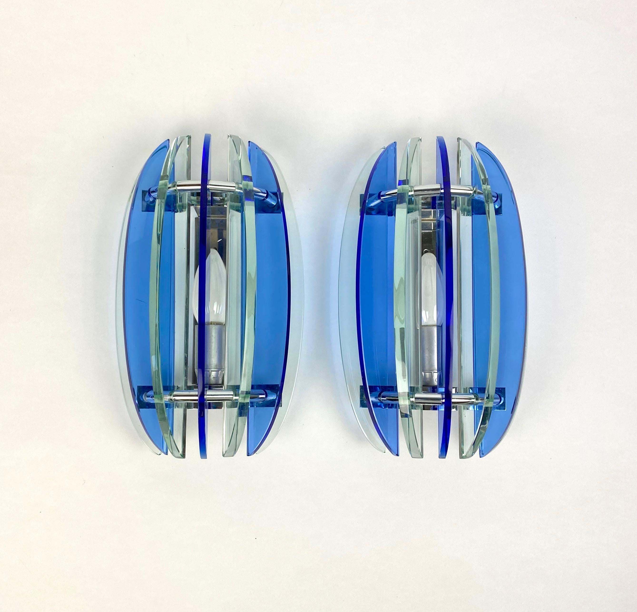 Pair of wall sconces in colored glass (blue and green) and chrome by Veca, Italy, 1970s. The original label is still attached.