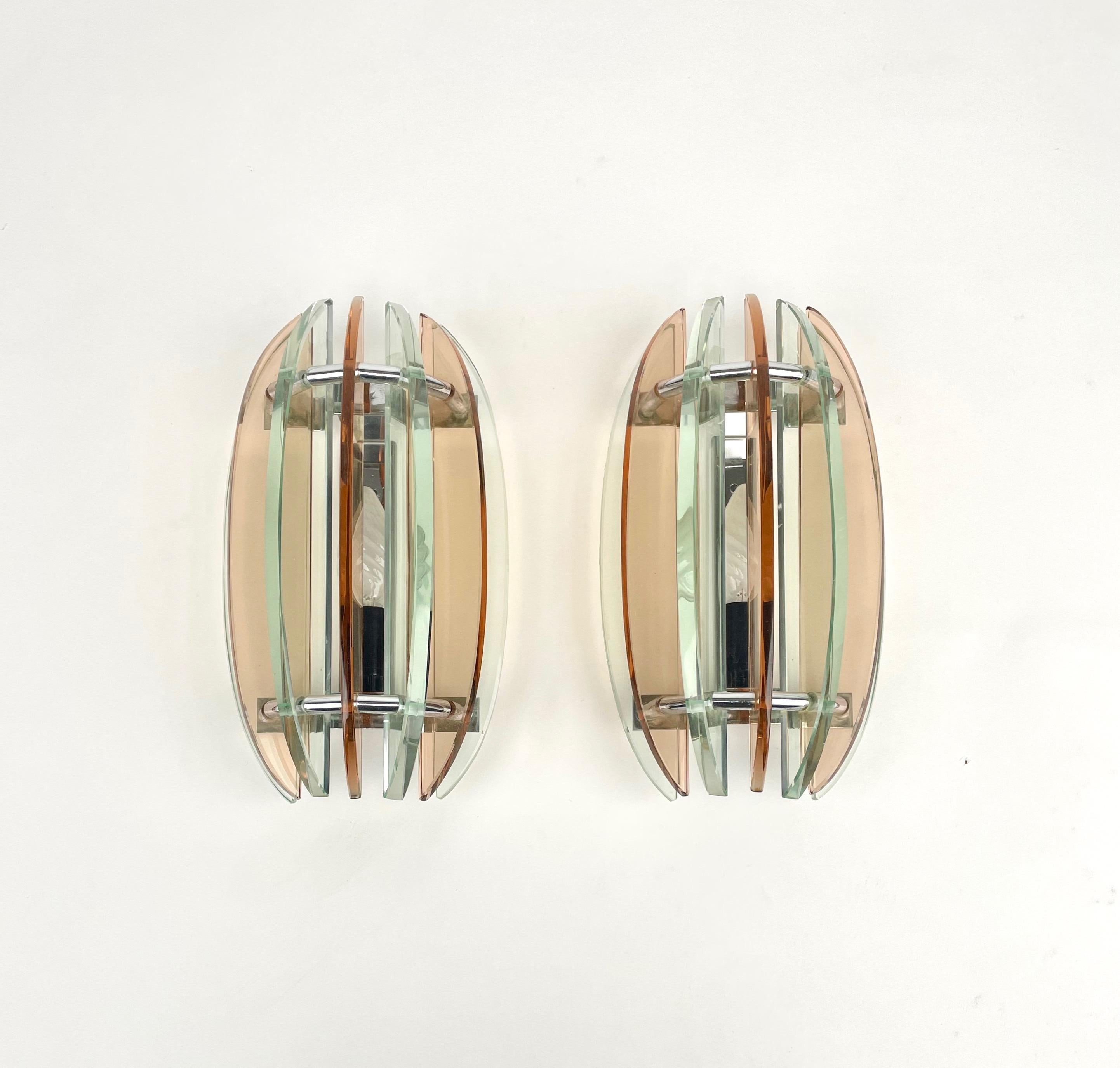 Pair of wall sconces in colored glass (pink and green) and chrome by Veca, Italy, 1970s.

The original label is still attached.