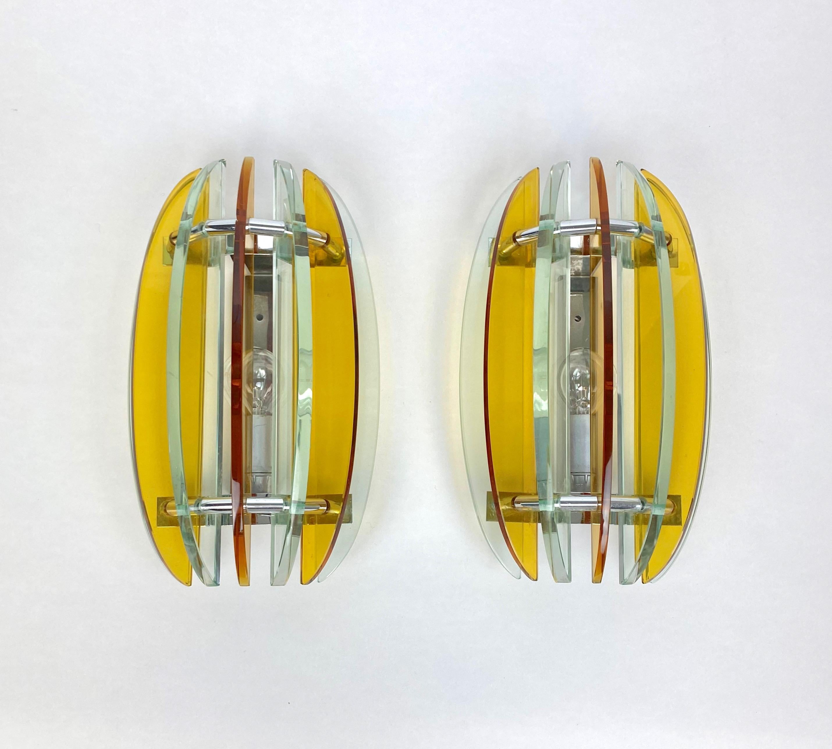 Pair of wall sconces in colored glass (yellow, orange and green) and chrome by Veca, Italy, 1970s. 

The original label is still attached.