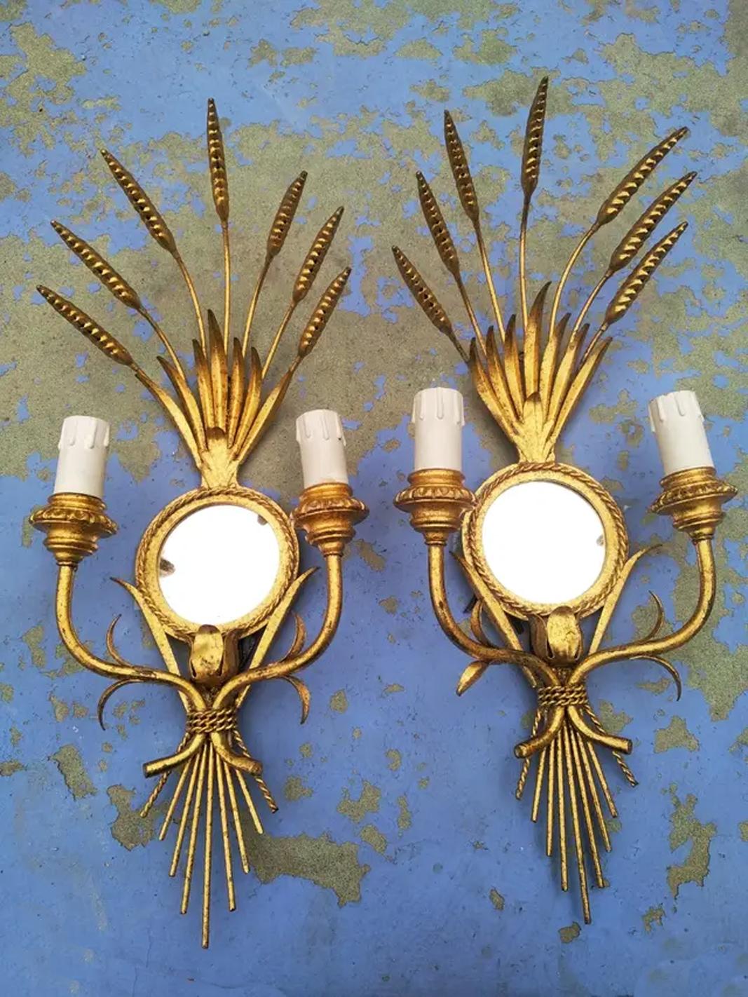 It could be from the house, Maison Bagues or Maison Charles or another similar French house,
Very good quality, beautiful couple

Wall sconces iron with gold leaf and mirror leves, midcentury 'Lot of Two'.

They keep a very beautiful color and are