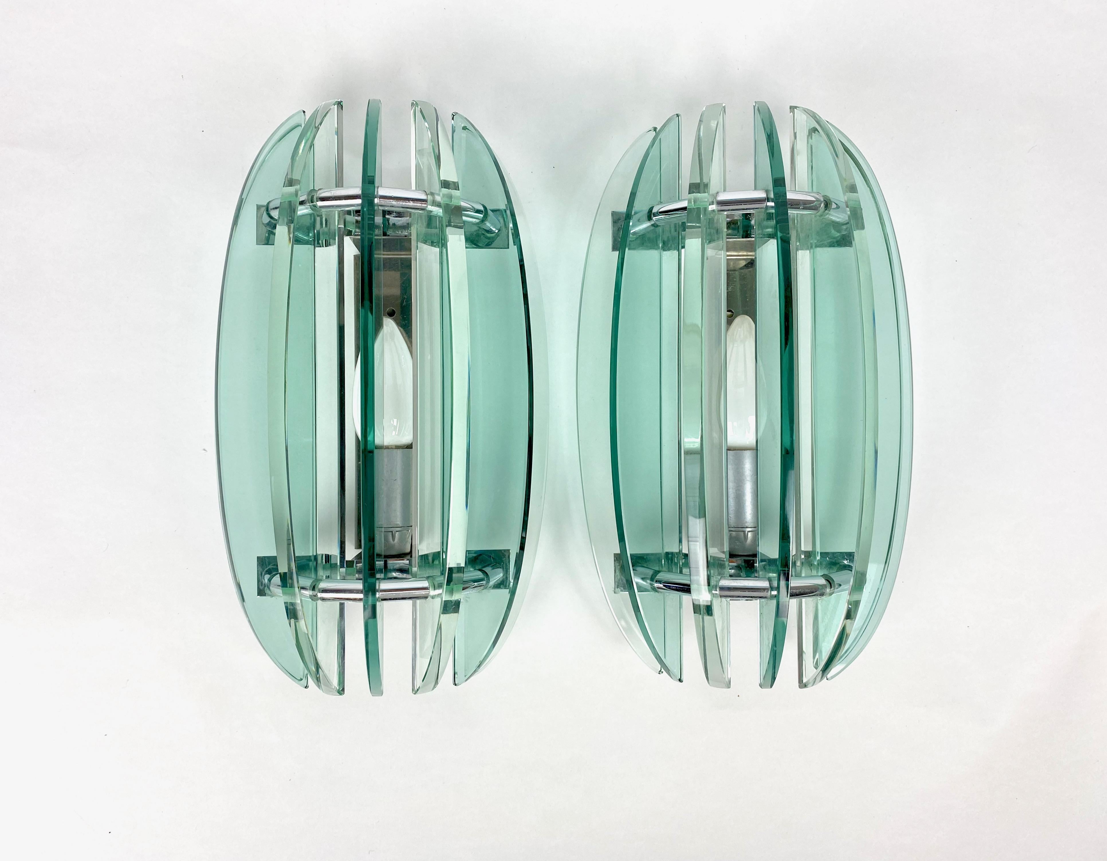 Pair of wall sconces in green glass and chrome by Veca, Italy, 1970s. The original label is still attached.