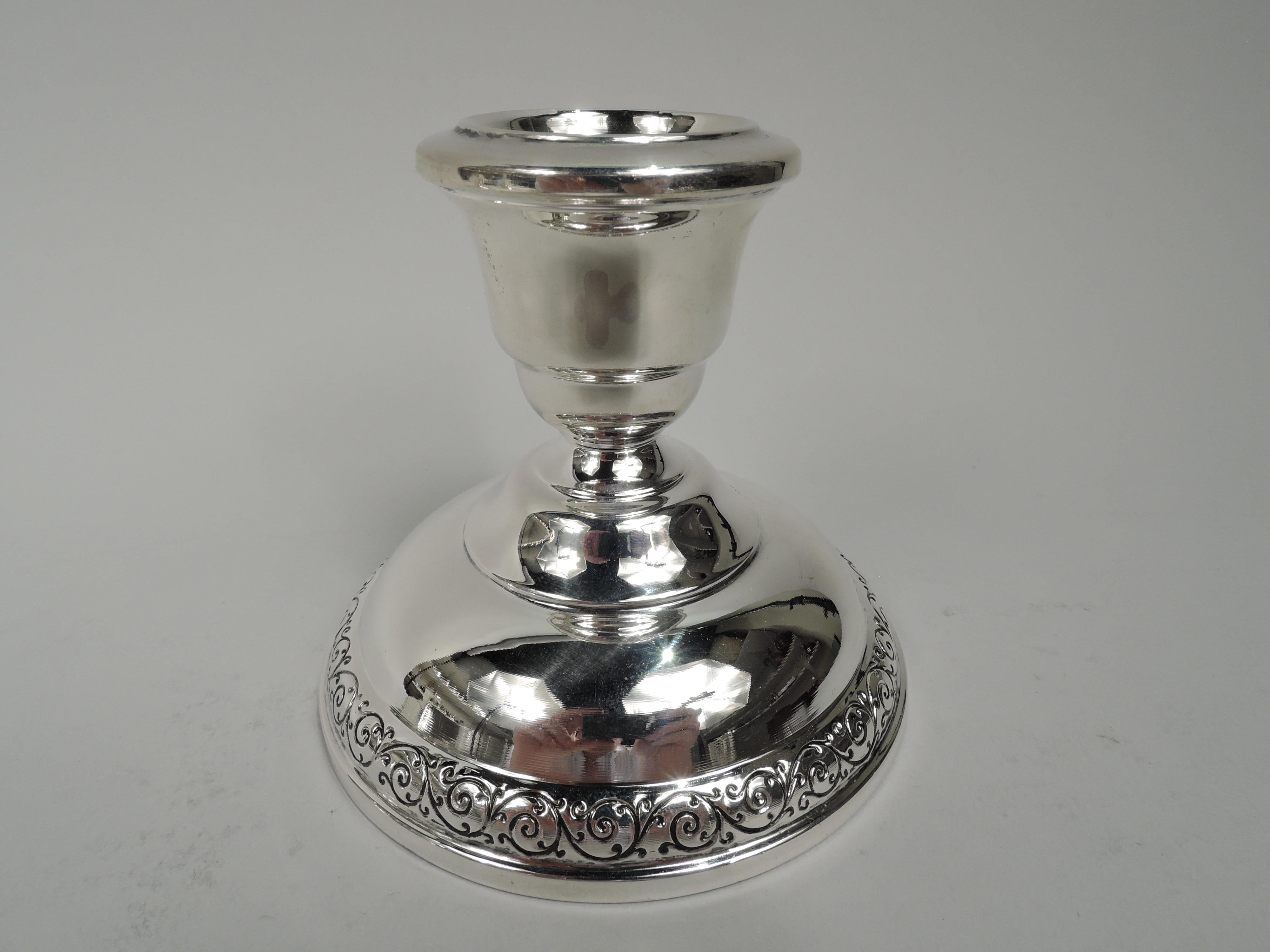 Pair of Spanish Lace sterling silver low candlesticks. Made by Wallace in Wallingford, Conn. Each: Urn socket on domed foot with tooled rinceaux rim border. Fully marked including maker’s stamp and no. 7117. Weighted.