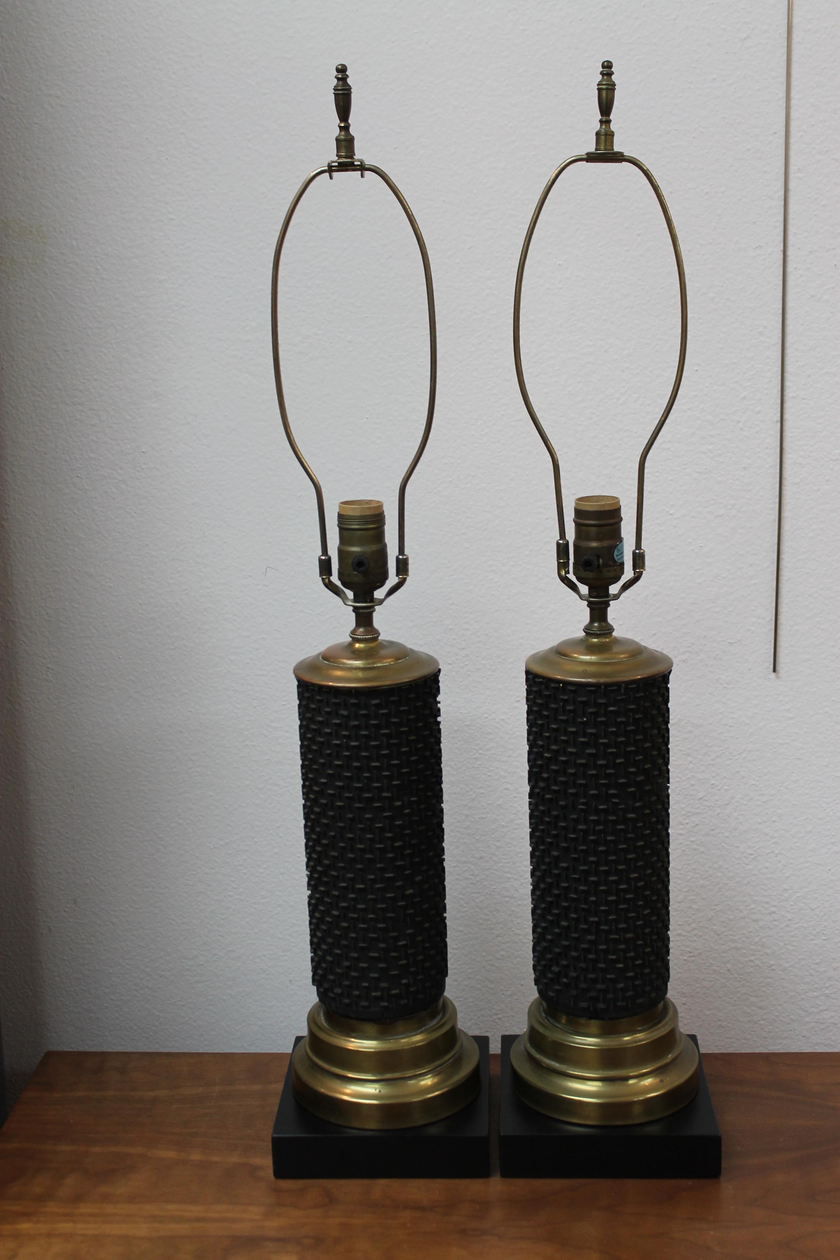 A matched pair of circa 1950s wallpaper print roller lamps, matte black with raised brass bars. Handsome horizontal / vertical pattern. These lamps are 16