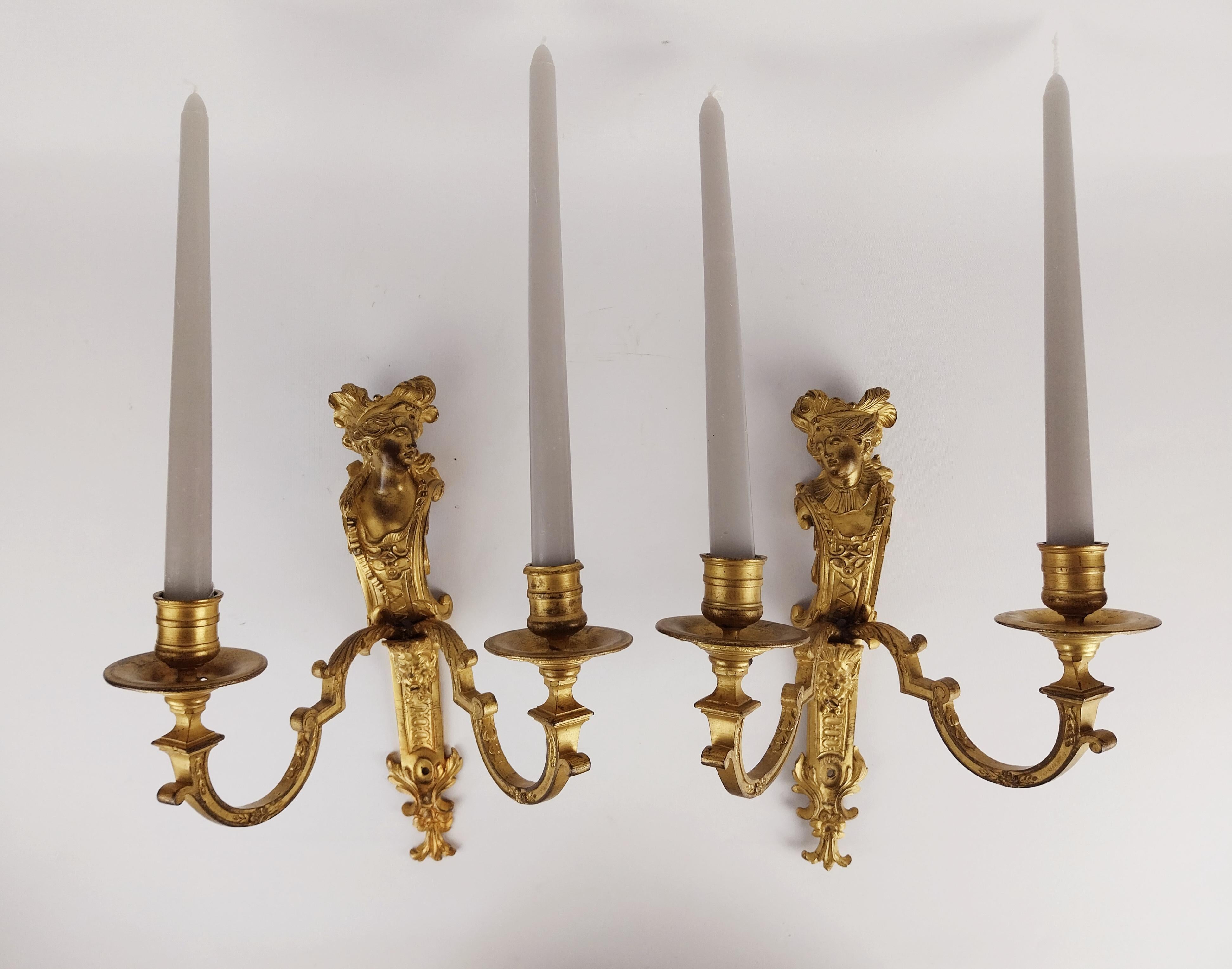 A quality Pair of French twin arm ornate antique gilded bronze wall candle sconces which are finely cast male and female heads looking towards each other that exude elegance and historical charm.
The quality of the casting is shown through out even