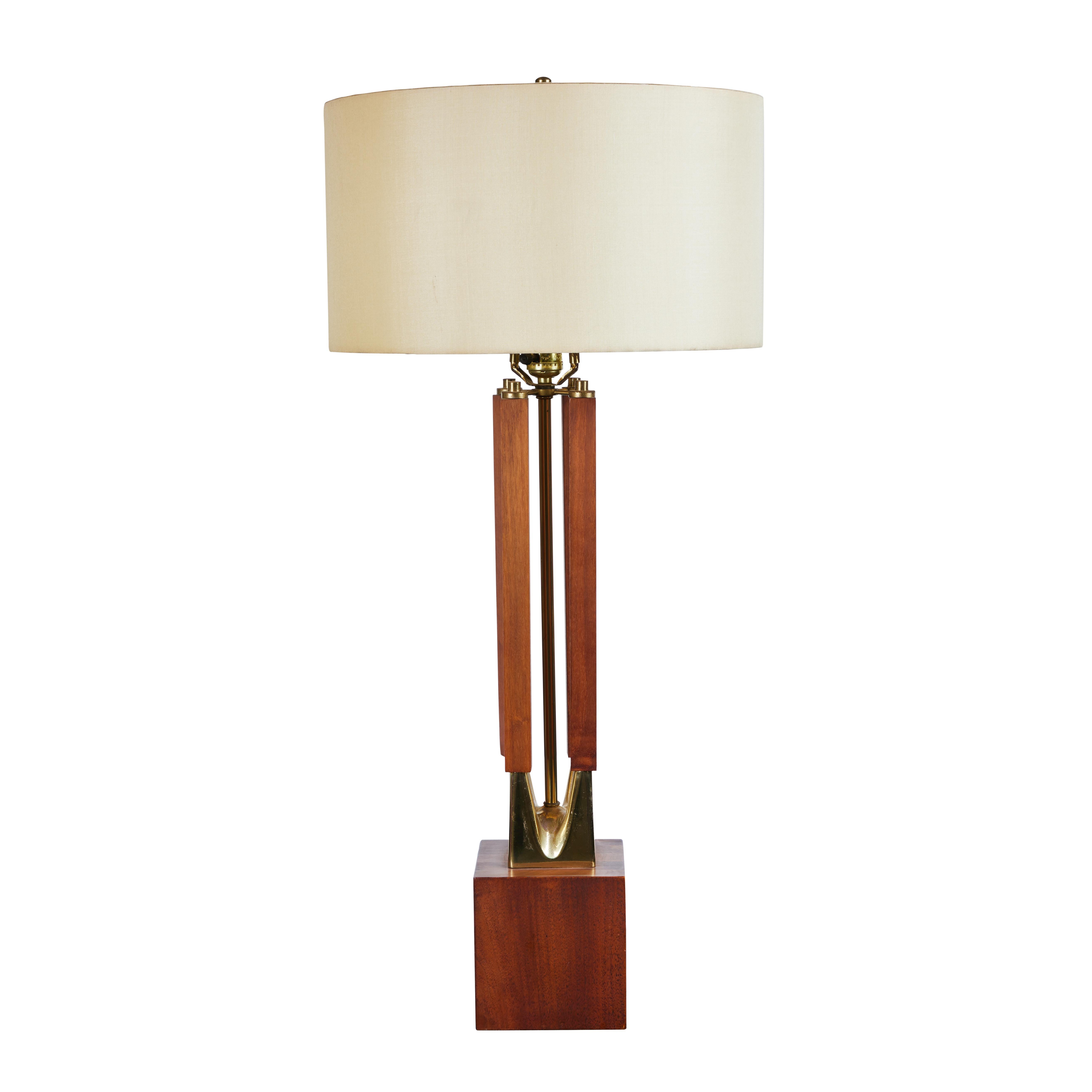 A stunning pair of large-scale lamps by Laurel Lamp Company, circa 1960's.  Handsome architectural form executed in solid walnut with brass accents, atop a solid walnut plinth.  mellowed to absolute perfection.  lamps are from an estate with one