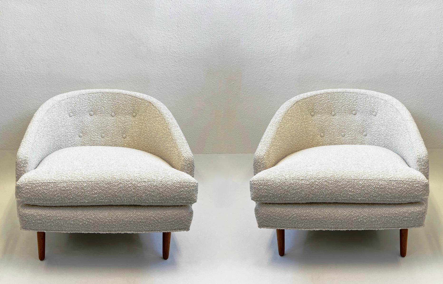 Glamorous pair of lounge chairs designed by Kipp Stewart in the 1960’s. 
Newly recovered with an off white fabric. The walnut legs are in original vintage condition, they show minor wear consistent with age. 

Measurements: 31” Deep, 29” Wide, 28”
