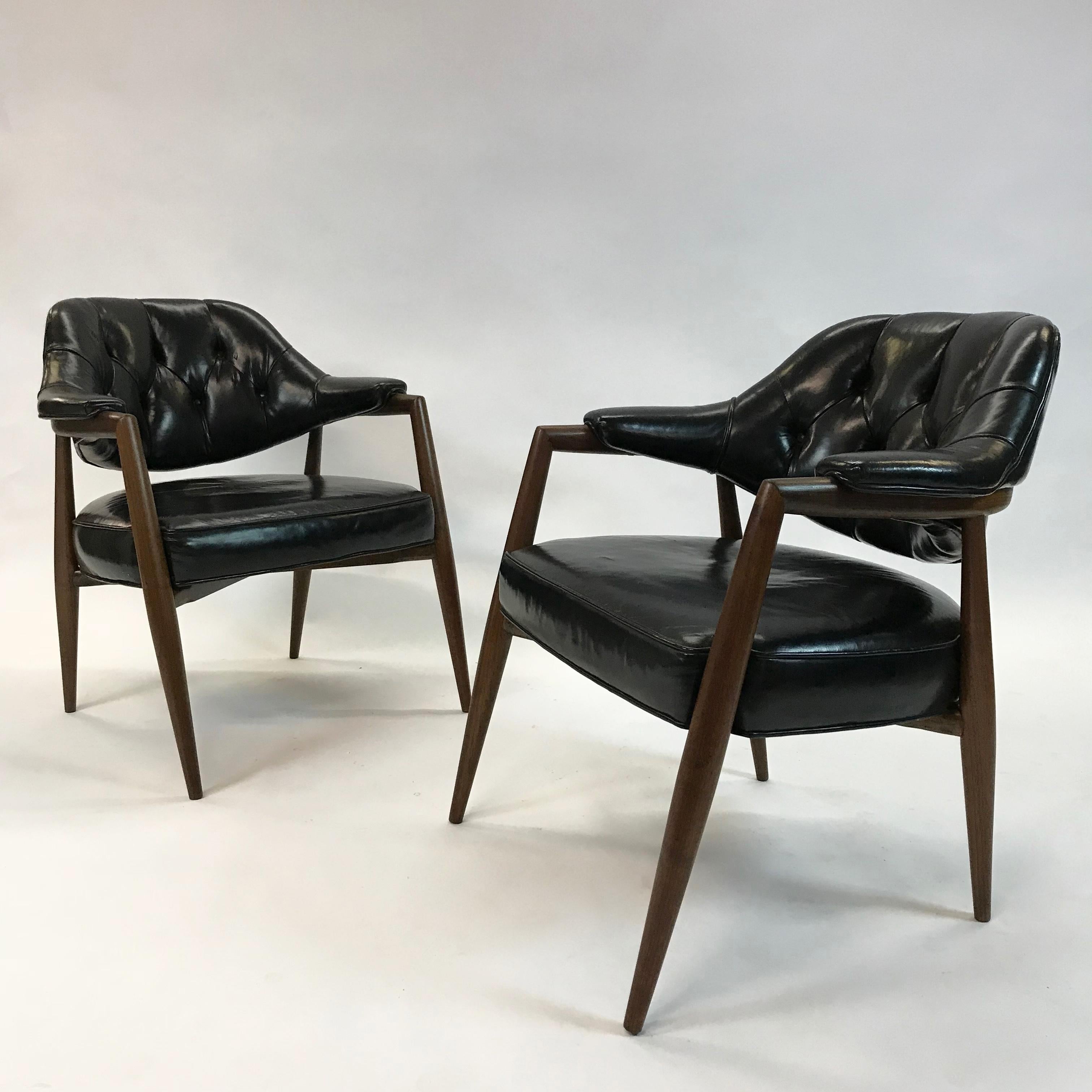 Pair of walnut armchairs by Maurice Bailey for Monteverdi-Young feature tufted backs in their original black leather upholstery.