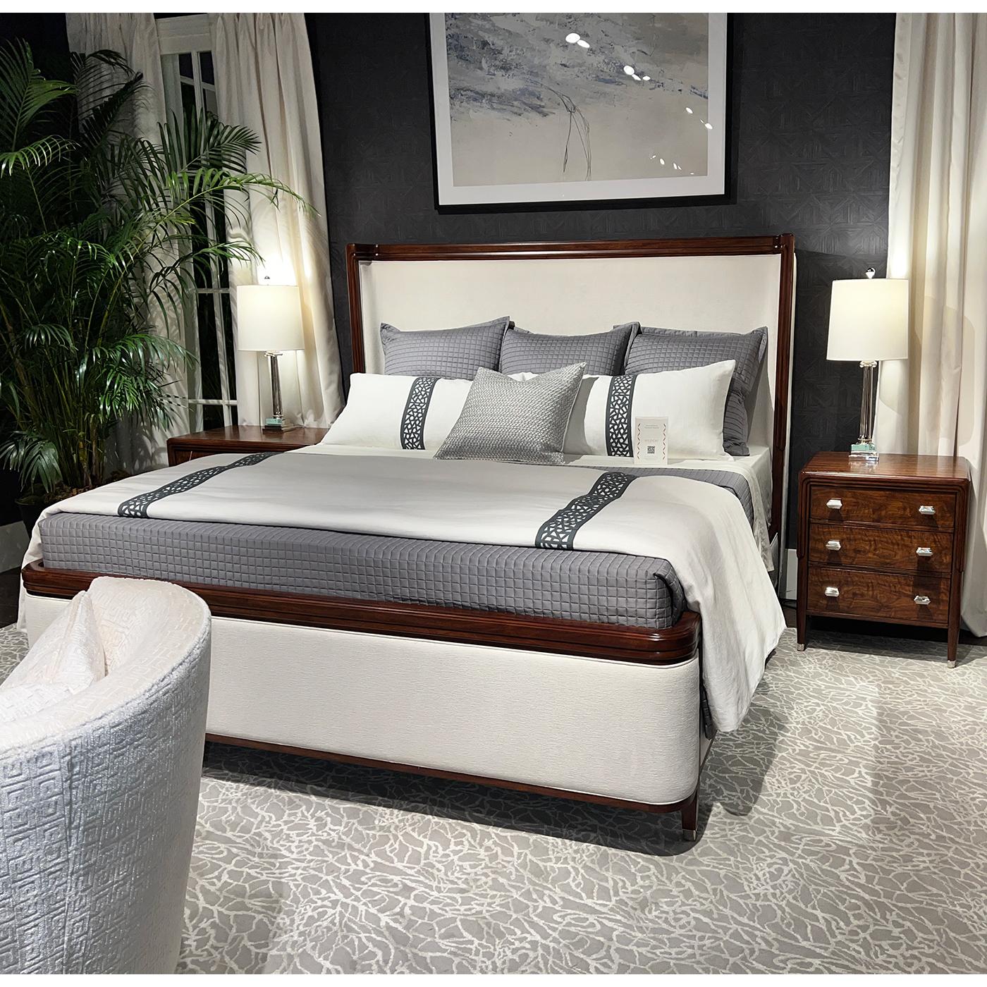 Embodying the refined luxury of early 20th-century design, this bedside chest is crafted with exquisite figured walnut, showcasing a rich wood grain that adds depth and character. Its poised silhouette is enhanced by expertly tapered legs and subtle