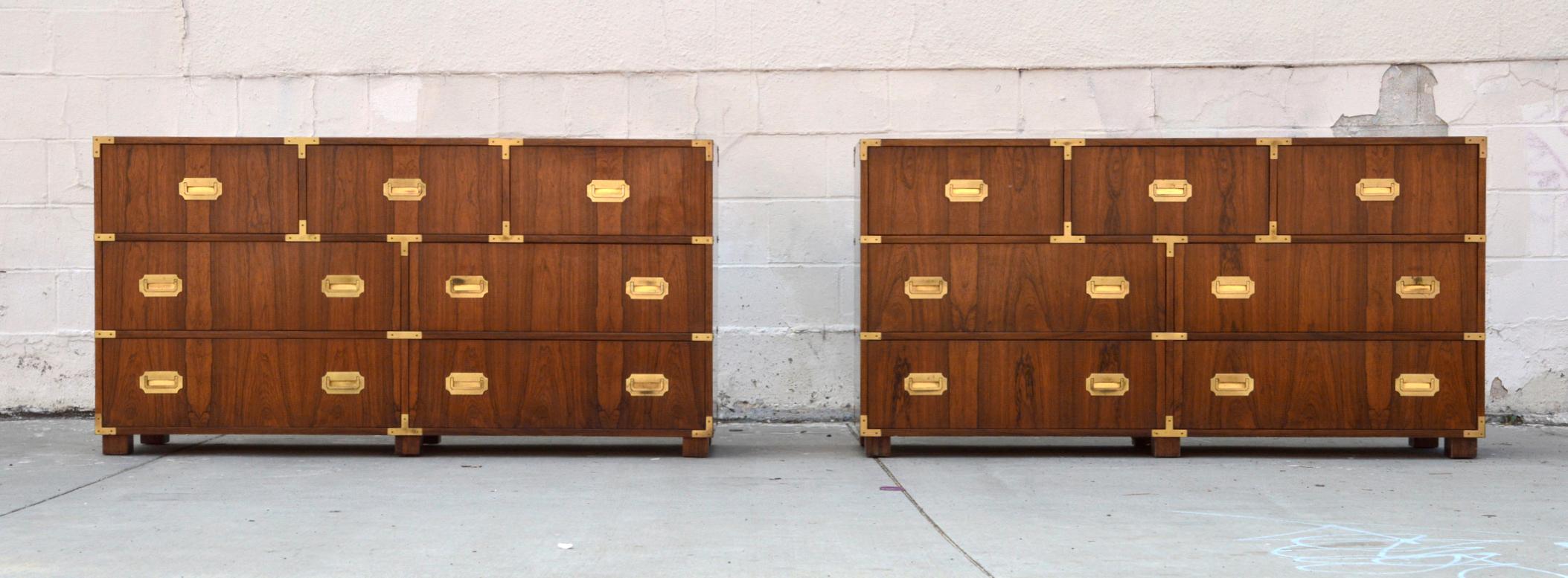 This pair of Campaign style baker chests of drawers each have 7 drawers and are made from bookmatched walnut with brass pulls. The careful book matching can be seen throughout the piece.

While they are listed here as a pair we would also consider