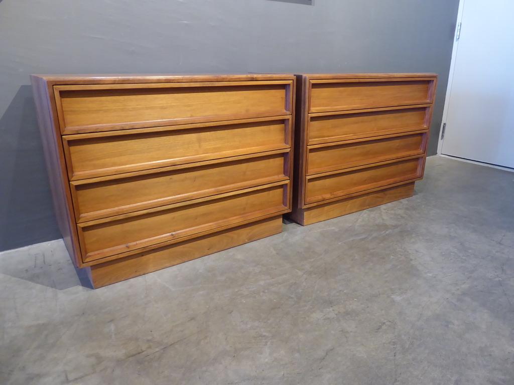 A pair of walnut four-drawer bedside chests, designed by John Keal and made by the Brown-Saltman Company in the 1960s. The chests are made from solid walnut and walnut veneers. Each of the drawers has a 