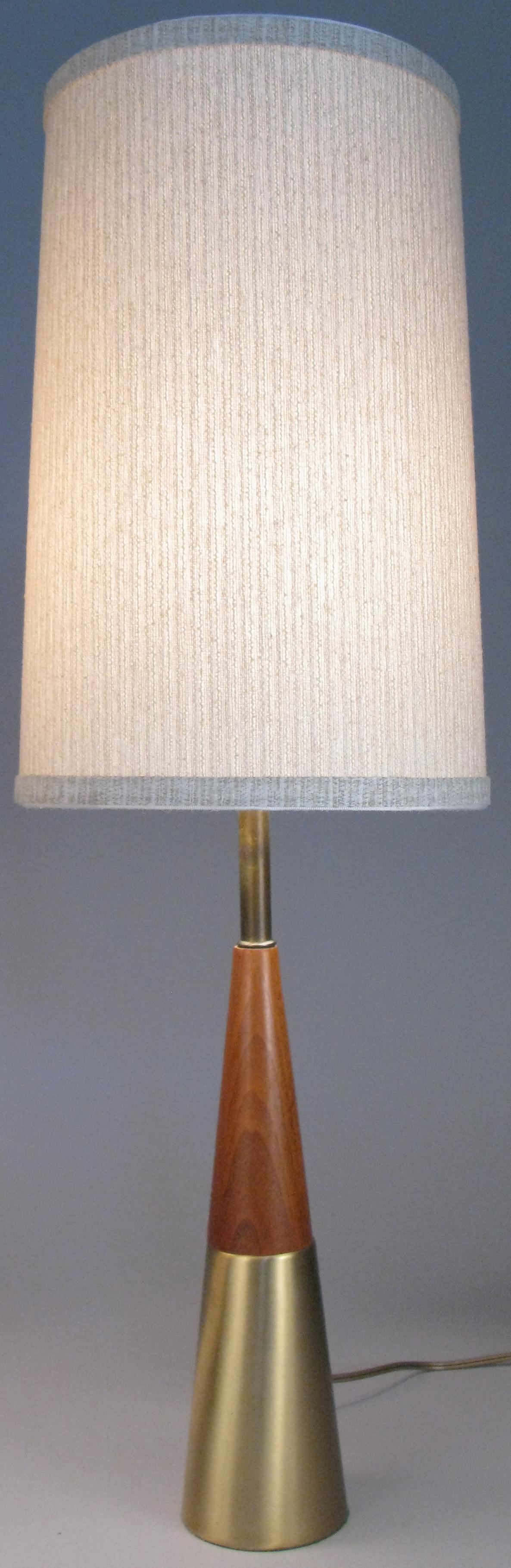 A very handsome pair of vintage 1960s table lamps with tapered bases of polished brass and walnut, designed by Tony Paul. With newly recovered shades.