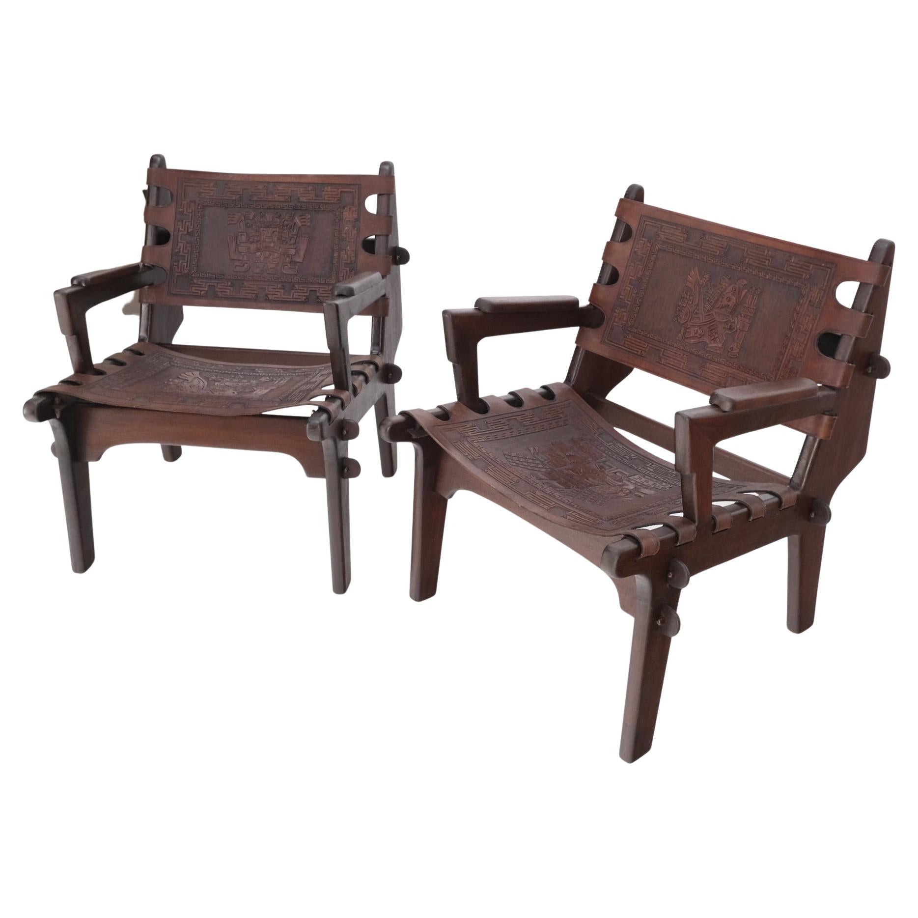 Pair of walnut carved tolled leather sling seats arm chairs by Angel Pazmino.