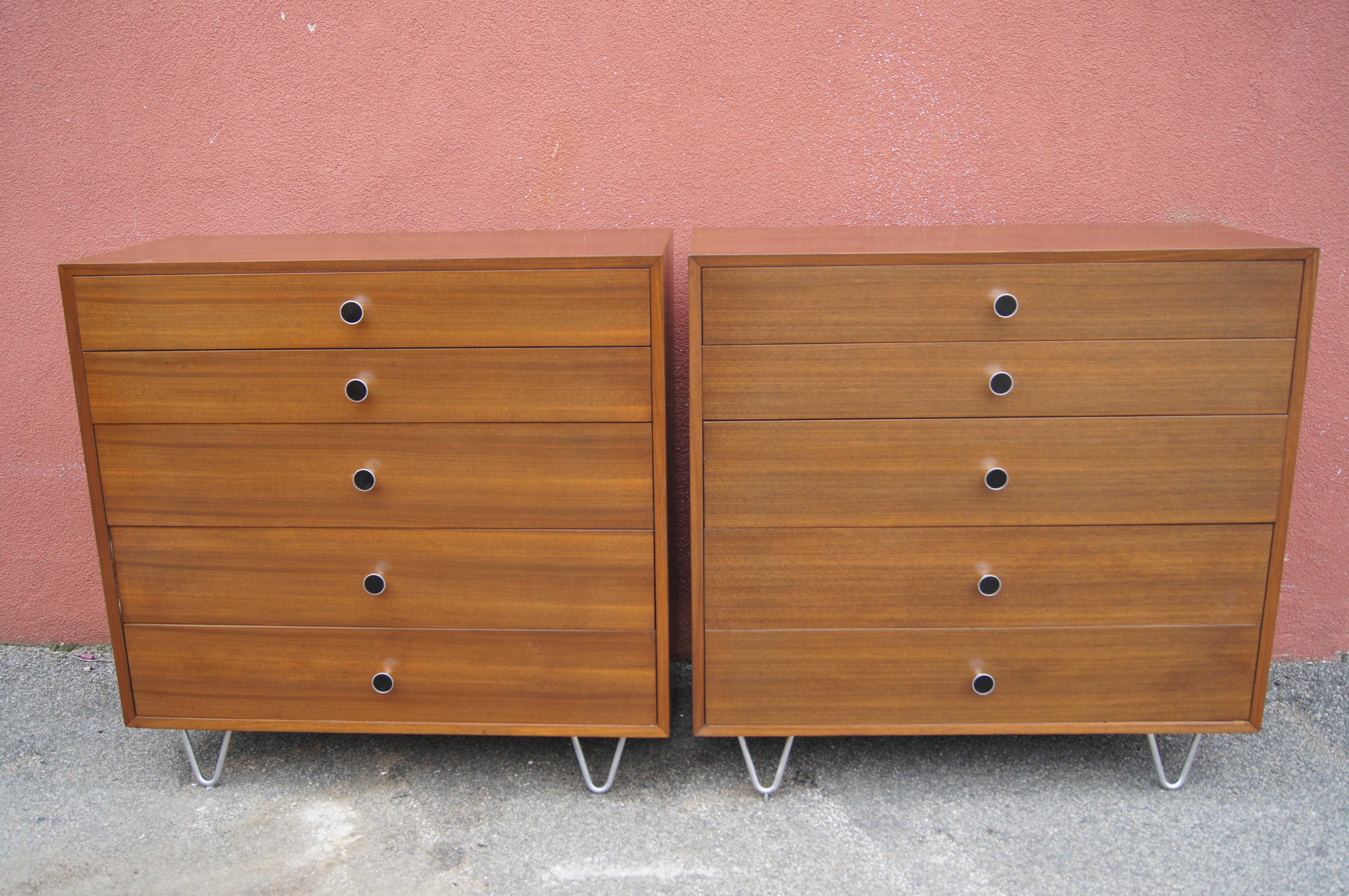 This pair of walnut dressers, modeled after the designs of George Nelson for Herman Miller, were produced by Highlands Woodcraft of Massachusetts in the 1950s. Each dresser has five drawers: three deep drawers, one of which is divided into four
