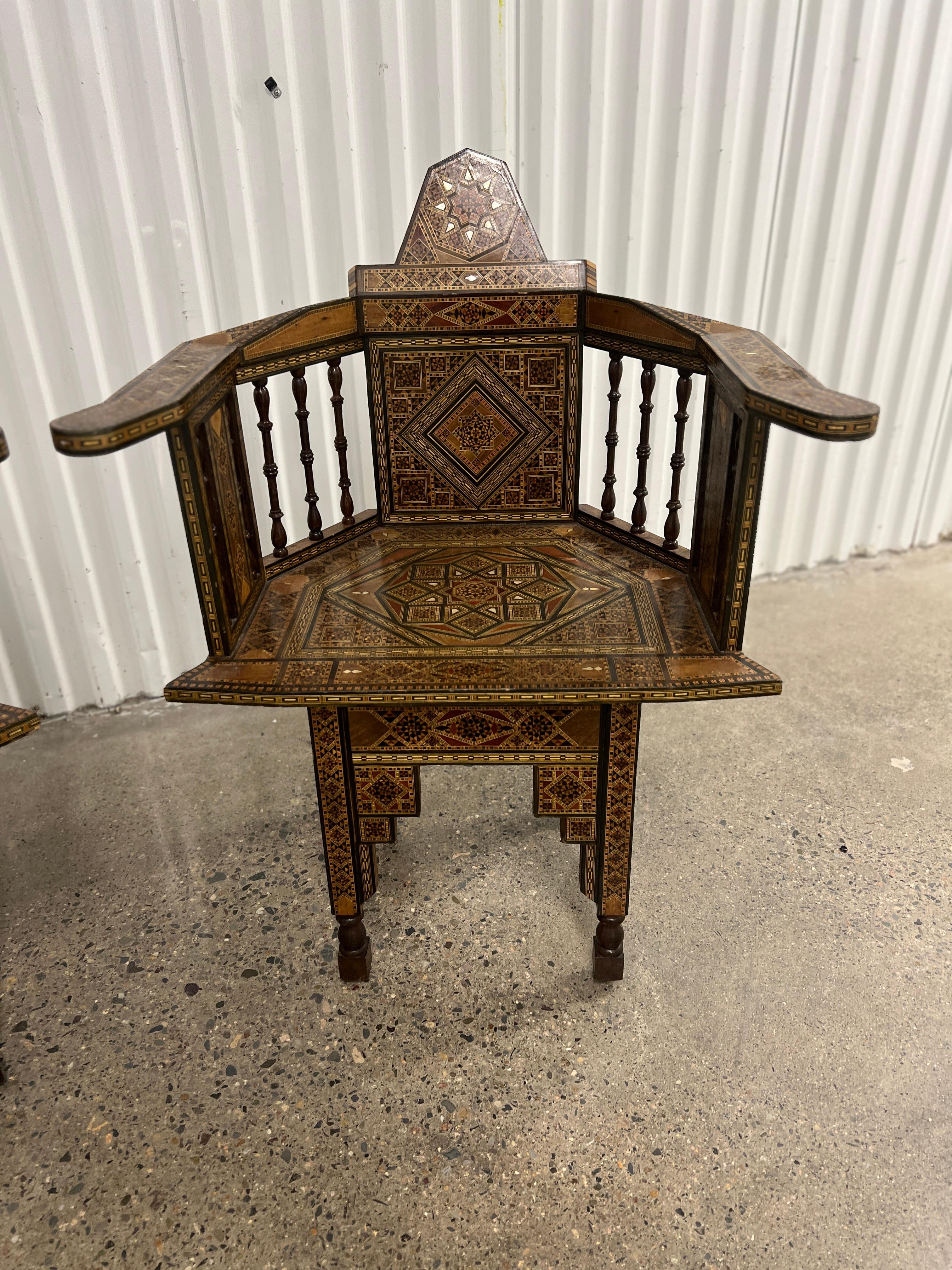 Syrian, early to mid 20th century.

A matched pair of unique and impressively inlaid Moorish armchairs. Each chair features immense inlay to every surface of the chair - from the mother of pearl, ebony and mixed exotic wood inlay to the crown,