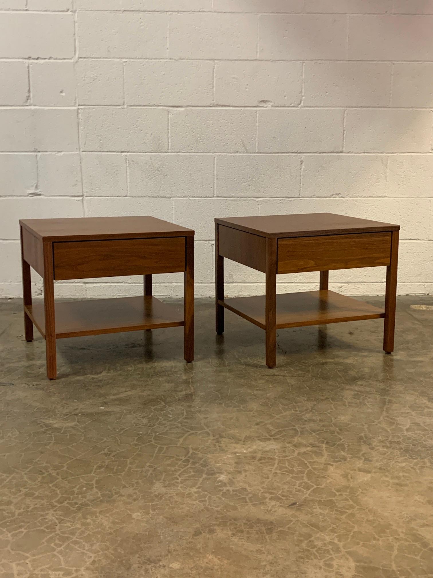 A pair of walnut nightstands designed by Florence Knoll for Knoll.