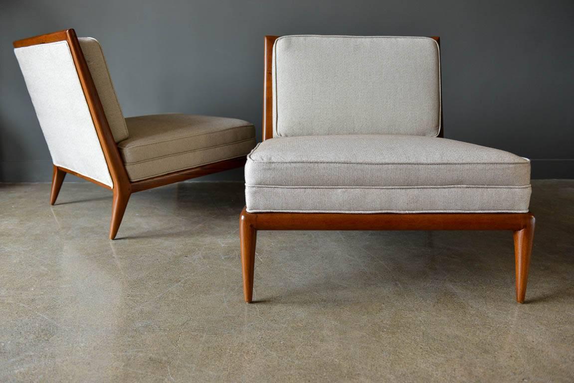 Pair of walnut frame slipper chairs, circa 1965 in the style of T.H. Robsjohn-Gibbings for Widdicomb. Beautiful walnut frames and new neutral upholstery. The wood grain on the chairs is excellent and they are extremely comfortable. Professionally