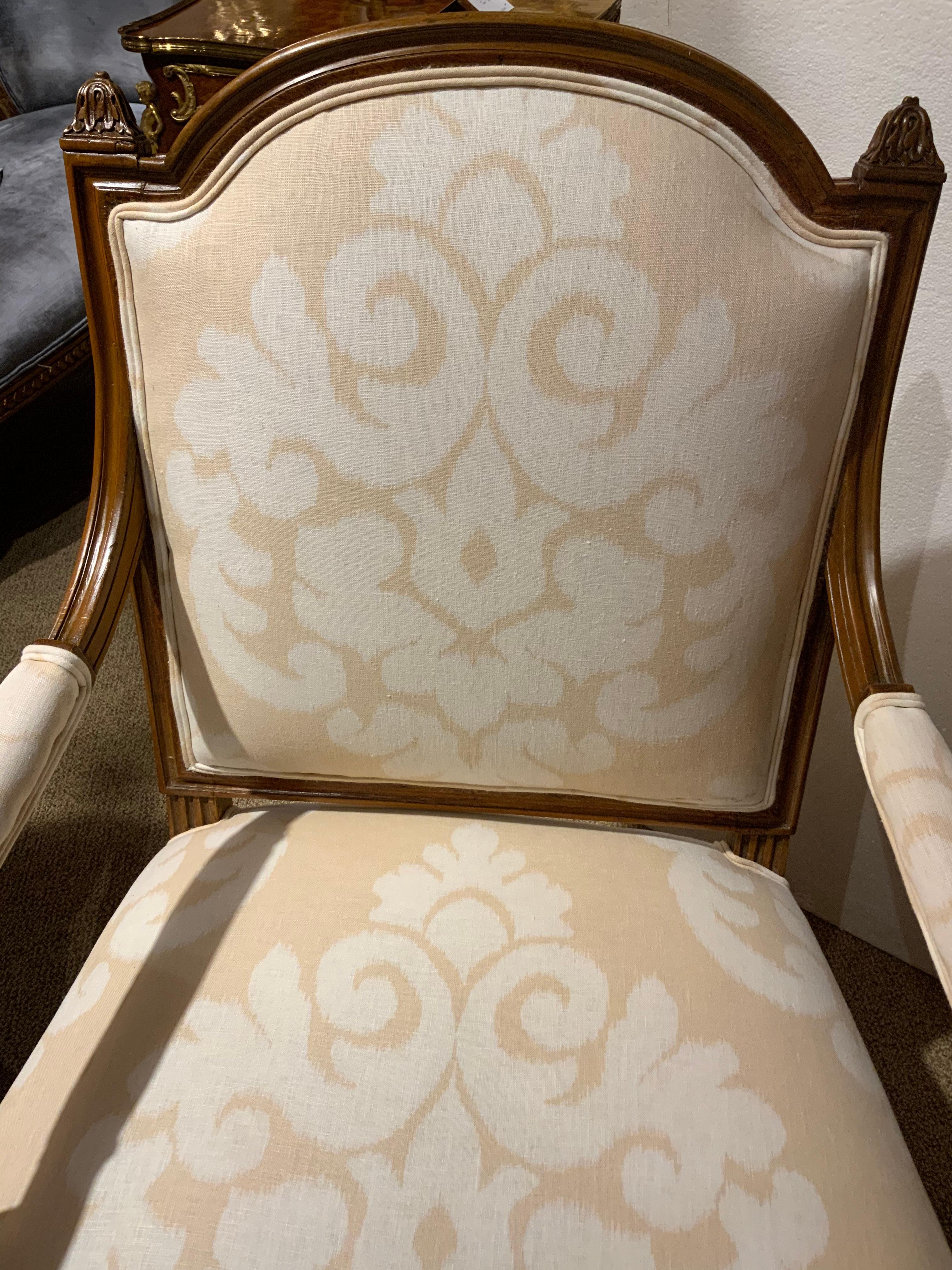 This pair of walnut Louis XVI -Style chairs have great proportion 
With a slightly domed back that is padded. They are newly
Upholstered with a fine linen designer fabric. The finish on the
Wood is in a warm brown hue. The legs are reeded and