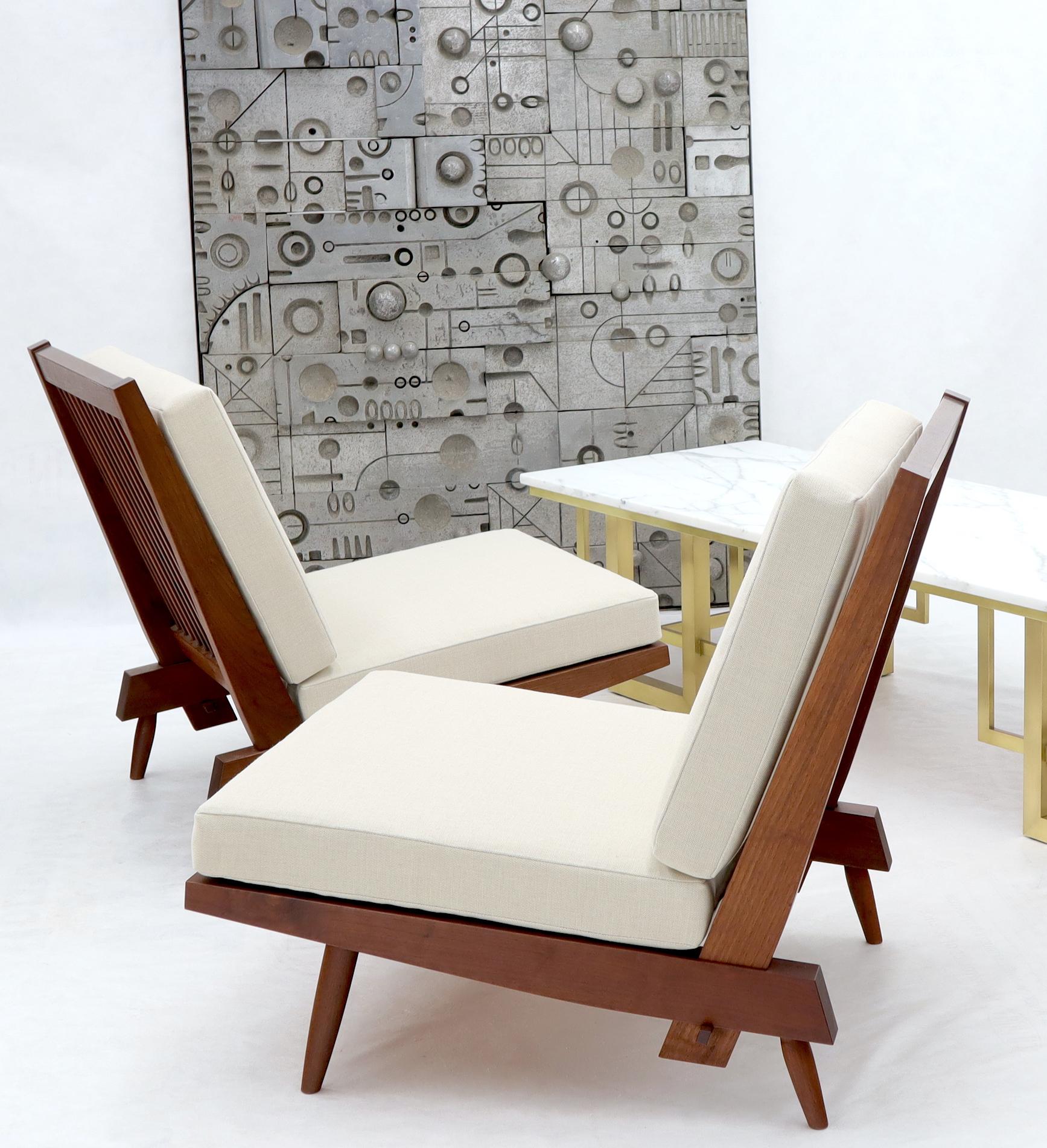 Pair of George Nakashima American walnut lounge chairs. Stunning jewelry like woodwork by George Nakashima from circa 1962. Excellent condition. New cushions.