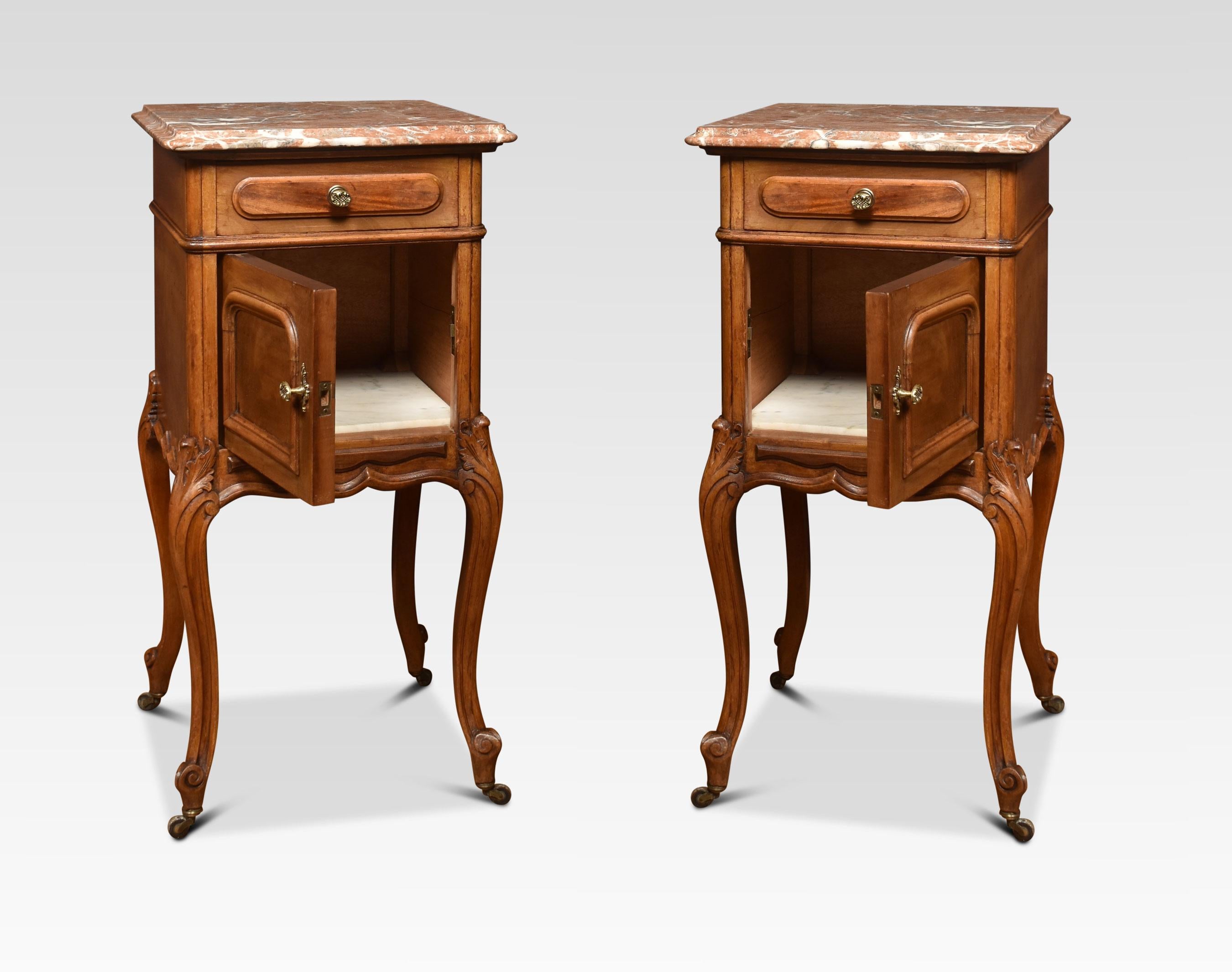 Pair of walnut bedside cabinets, The square red-veined marble tops with rounded corners over a single short drawer with gilt metal handles above a single panelled cupboard door all raised up on four slender cabriole legs terminating in