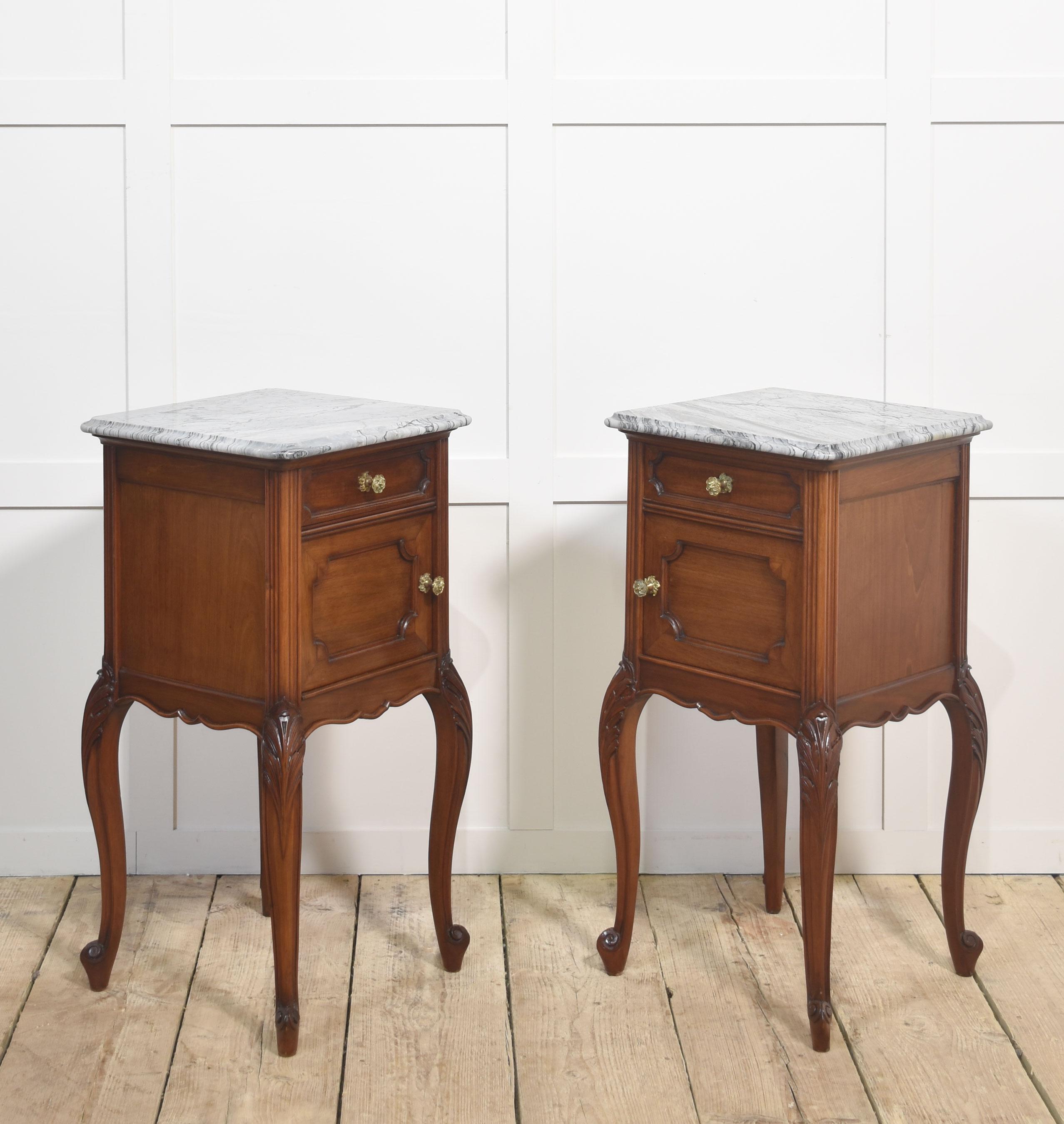 Pair of walnut bedside cabinets, the square well-figured marble tops with rounded corners over a single short drawer with gilt metal handle above a single panelled cupboard door opening to reveal a ceramic-lined interior, all raised on four slender