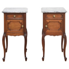 Pair of walnut marble top bedside cabinets