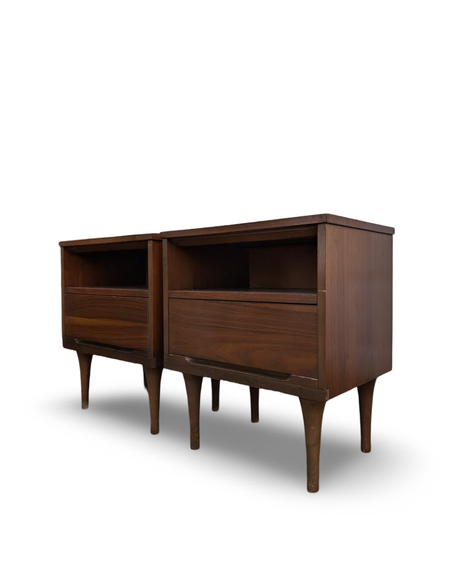 This pair of mid-century modern minimalist nightstands by Coleman of Virginia is a stunning addition to any bedroom. Featuring a smooth walnut finish, these nightstands showcase sleek tapered legs and a minimalist design that epitomizes the elegance