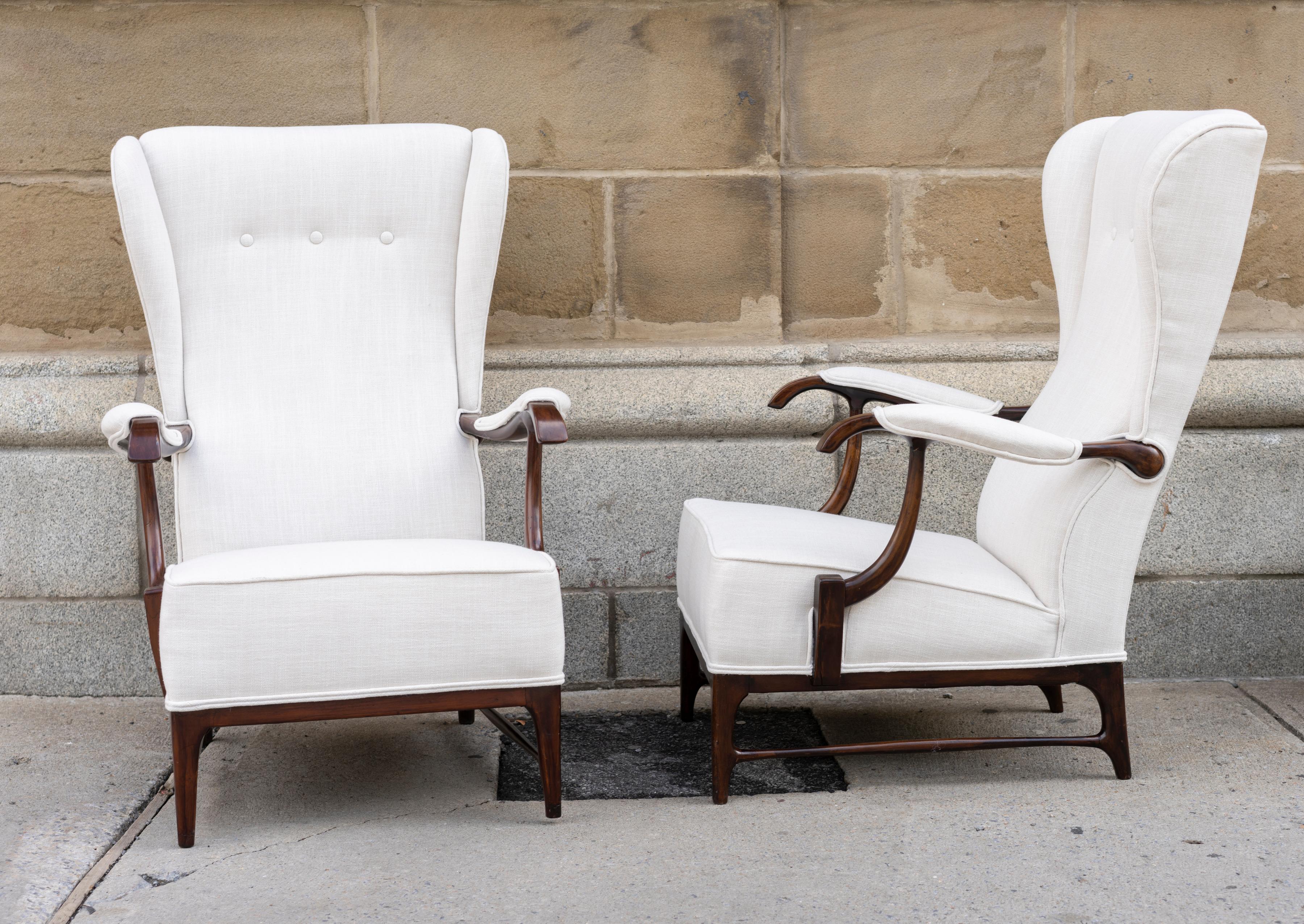 Pair of walnut Mid-Century Modern, upholstered wingback armchairs by Paolo Buffa.