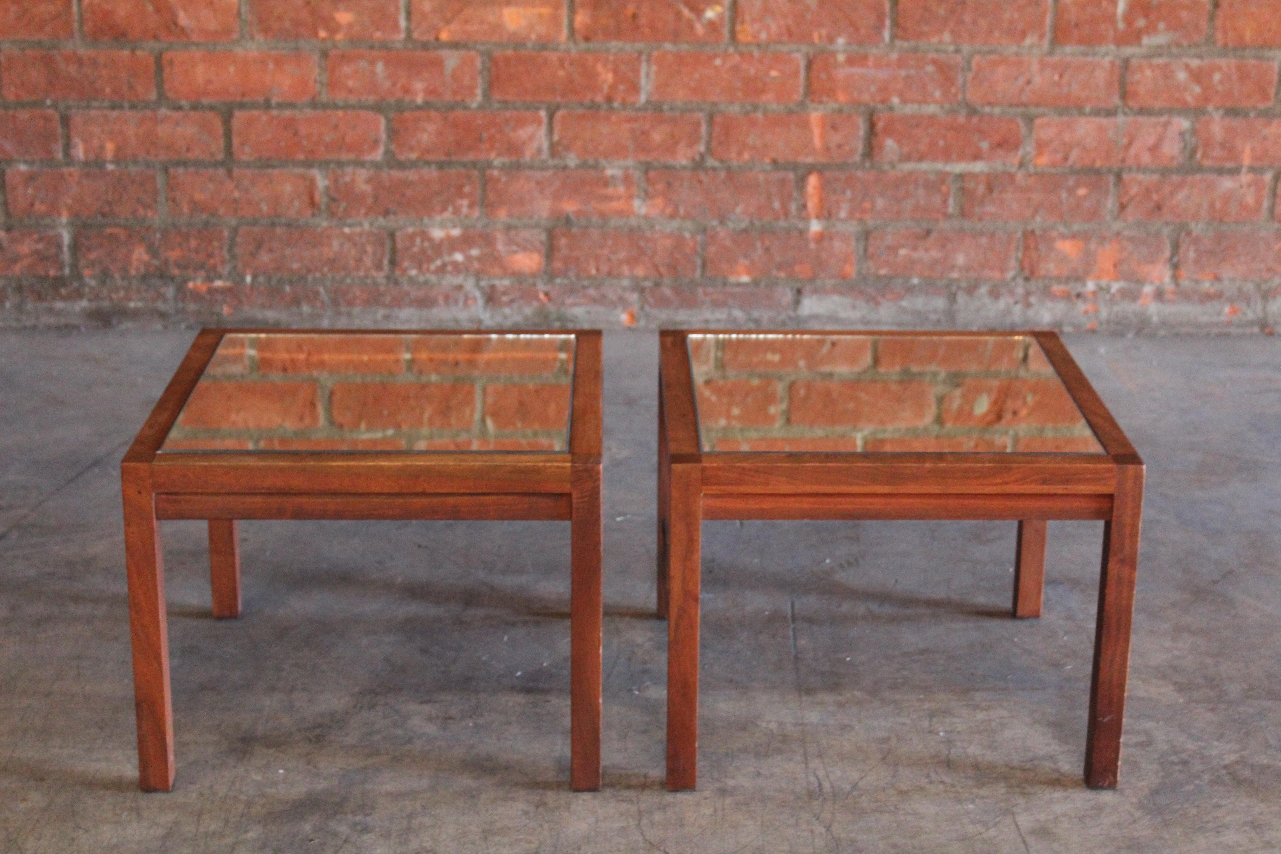 Pair of 1960s solid walnut side or end tables with mirrored tops.