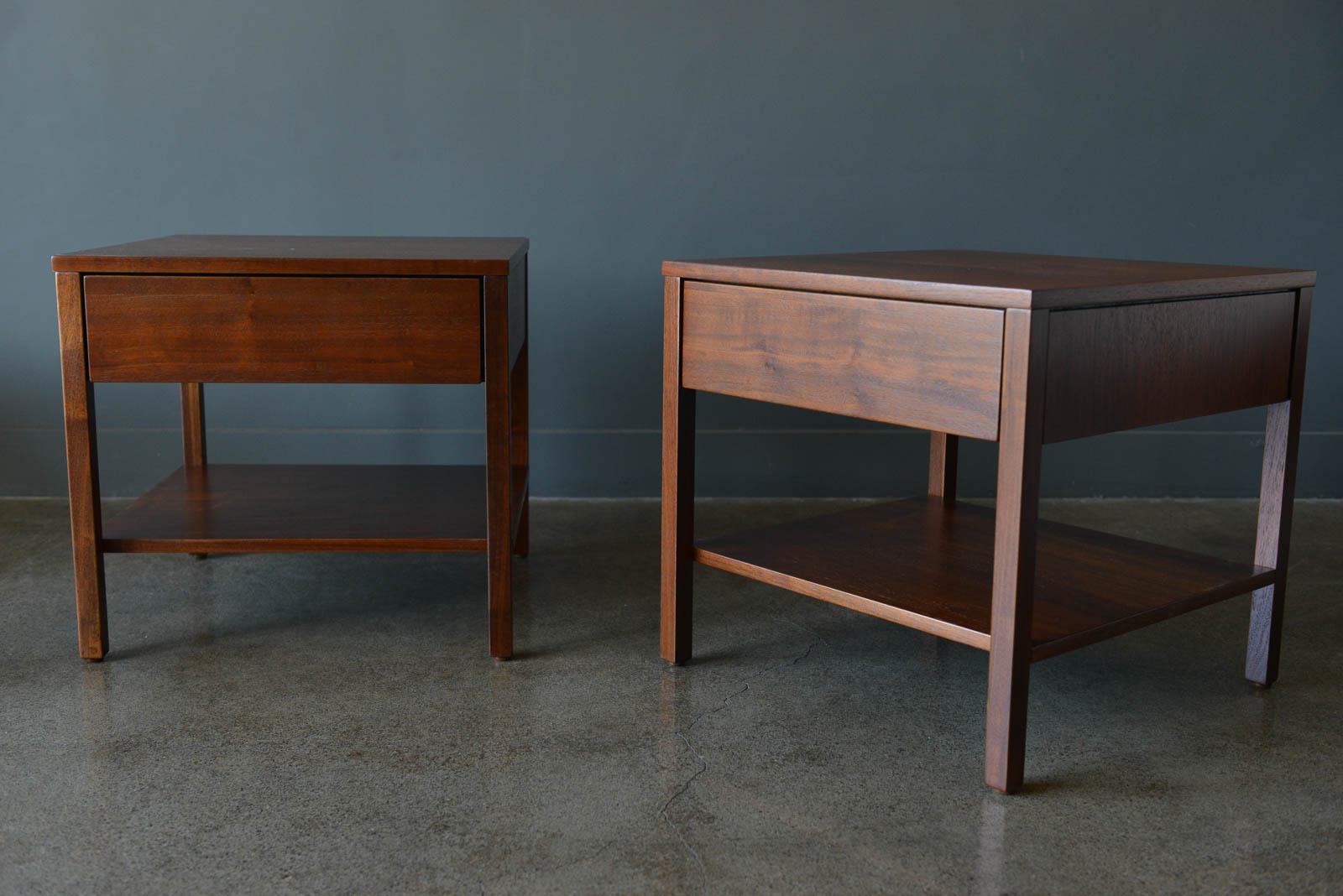 Early pair of walnut nightstands or side tables by Florence Knoll, ca. 1951. Beautiful walnut grain with original drawer dividers and tissue holder. Professionally restored in showroom condition. Measure 19.5 x 19.5 x 18.25 High.