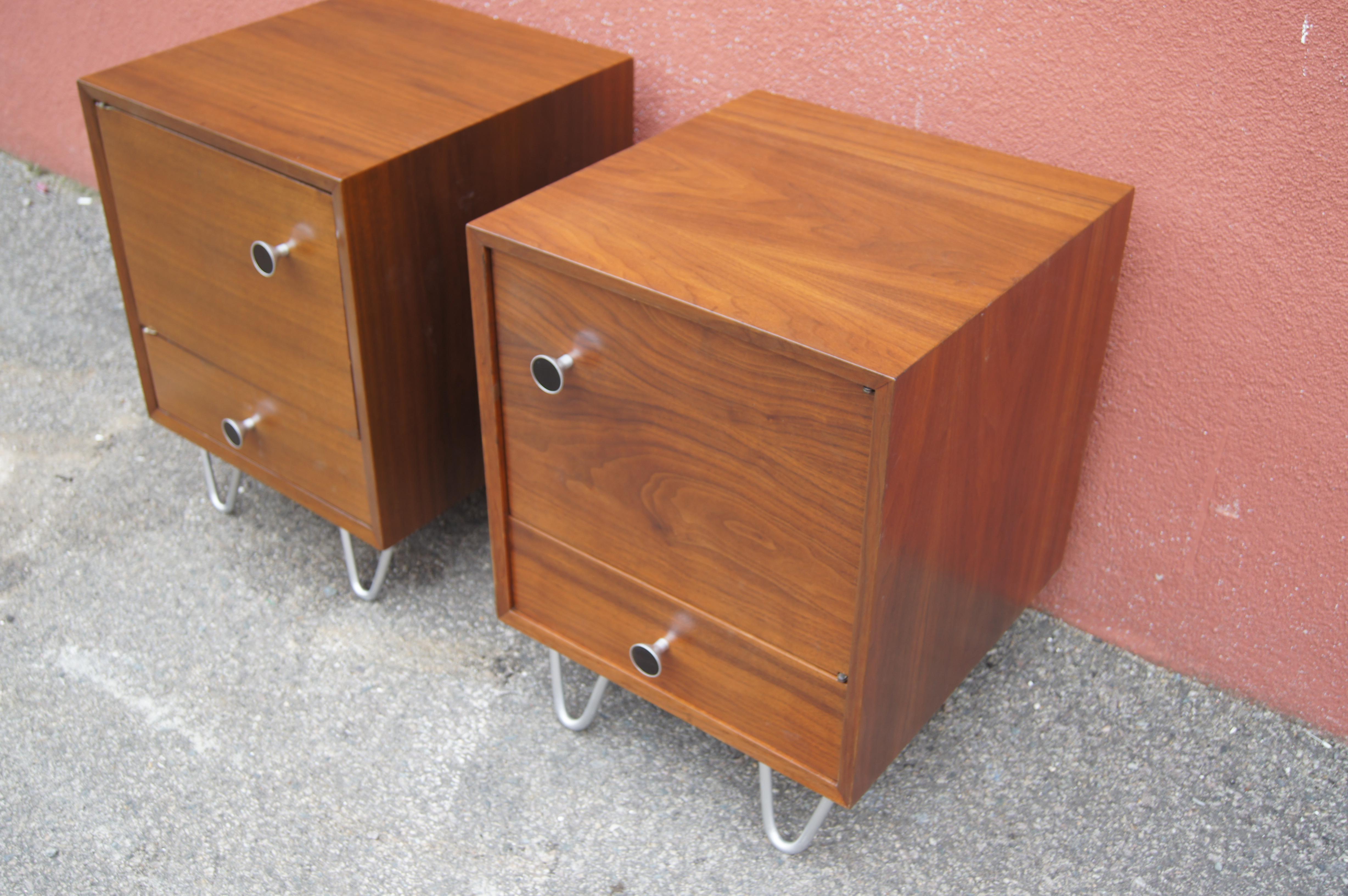 This pair of walnut nightstands, modeled after the designs of George Nelson for Herman Miller, were produced by Highlands Woodcraft of Massachusetts in the 1950s. Each cabinet door has two deep shelves and opens onto more storage space. Below is a
