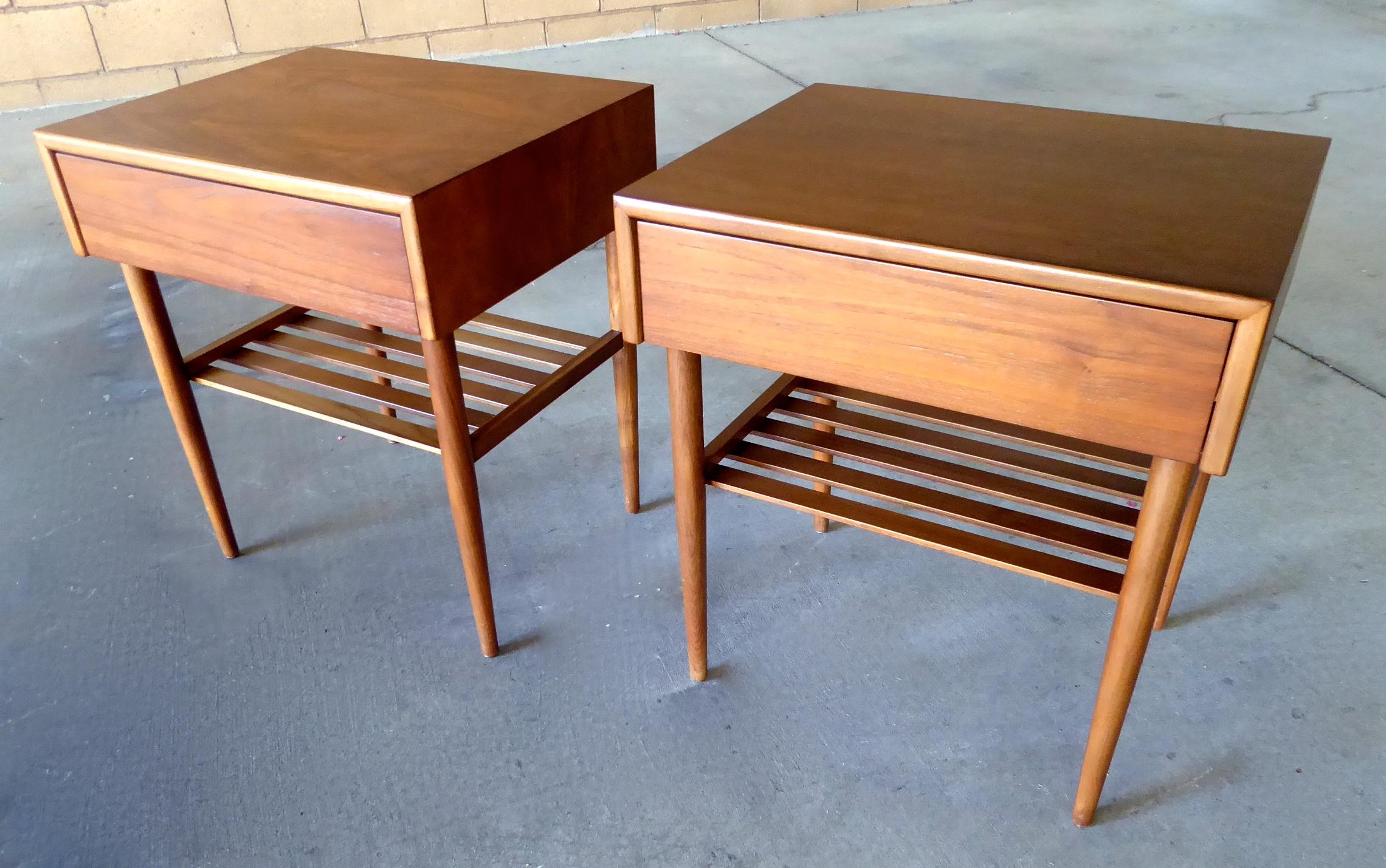 A pair of walnut bedside tables, each with a single drawer and slatted shelf, by California furniture company Brown Saltman, circa 1950s. Small and compact, these nightstands would be perfect in a second bedroom.