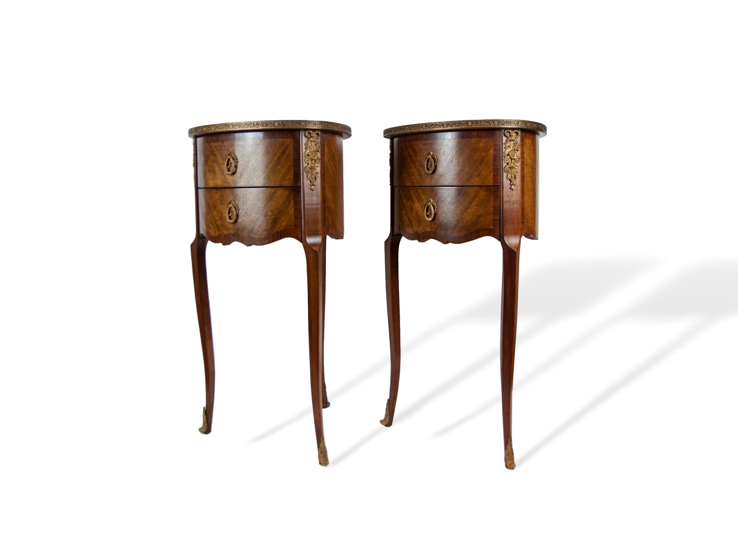 Pair of walnut rosewood banded two-drawer side tables, French, circa 1920, with gilded bronze mounts, sabots, and pierced edging. An unusual and graceful form, tear-drop shaped with three legs and three-sided, sold oak, dovetailed drawers.