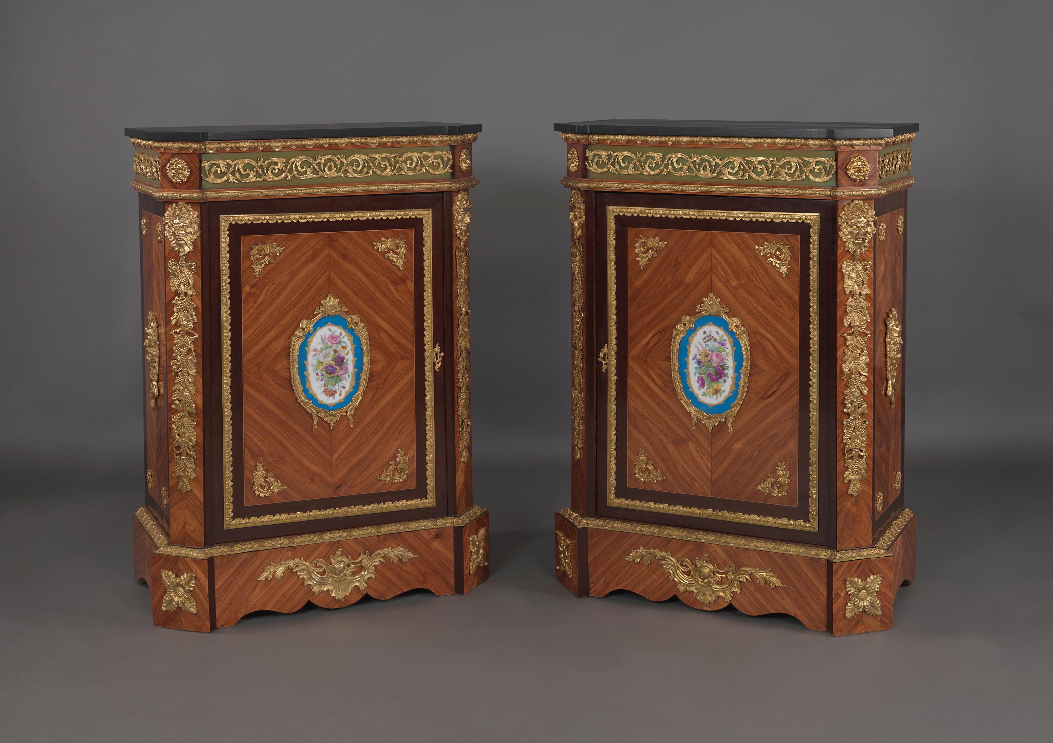 A good pair of gilt bronze-mounted walnut side cabinets with Sèvres-style porcelain mounts.

French, circa 1880. 

The rectangular tops having out-stepped corners above a single panel door centred by a porcelain plaque with foliate decoration.
