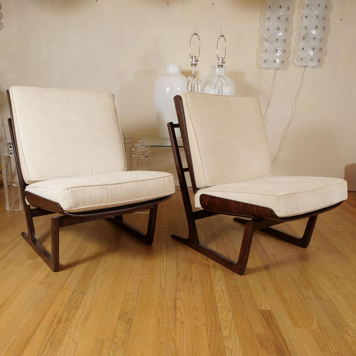 Pair of walnut stained maple chairs with upholstered seat and back.
1stdibs specialist’s recommendation is that these were made by Deco house, a company based out of Birmingham, Alabama. They were designed by Hans Juergens.