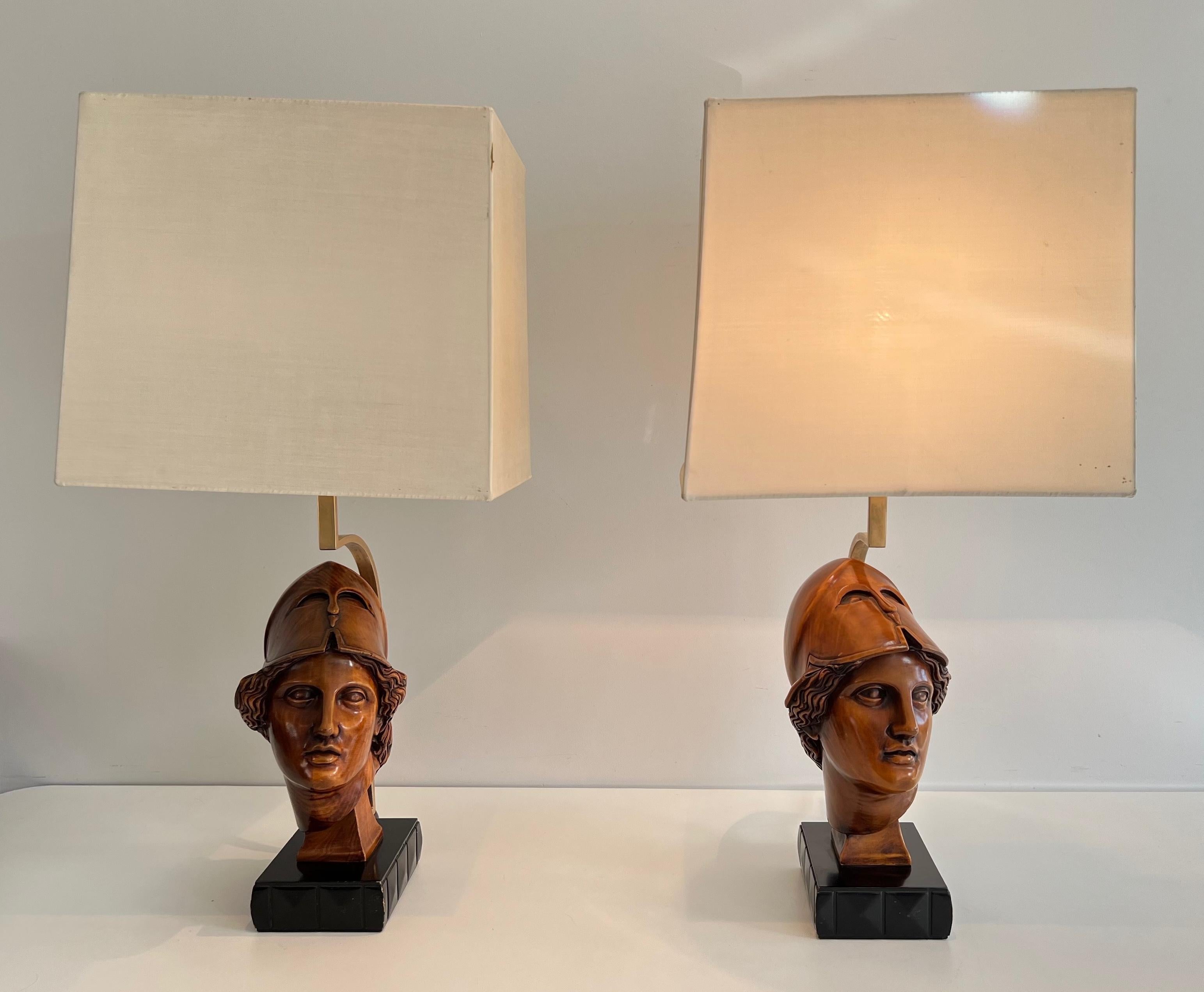 This stunning pair of table lamps is made of walnut. They represent faces of helmeted soldiers. This is an Italian work. Circa 1970