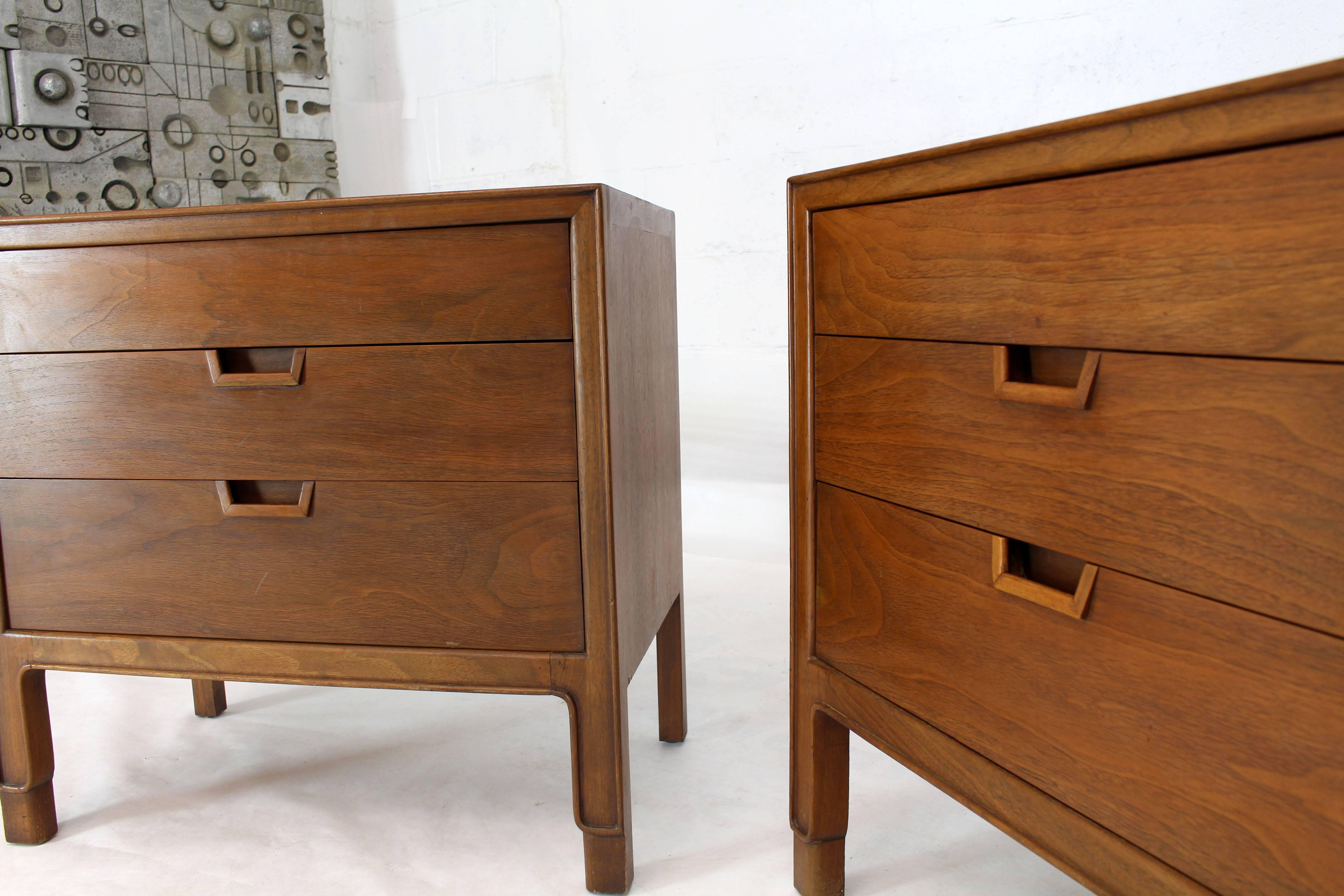 Pair of walnut Mid-Century Modern three-drawer end tables with beautiful solid walnut pulls. Nice carved detail near the bottom of the legs showing the solid structure and nature of the solid walnut wood.