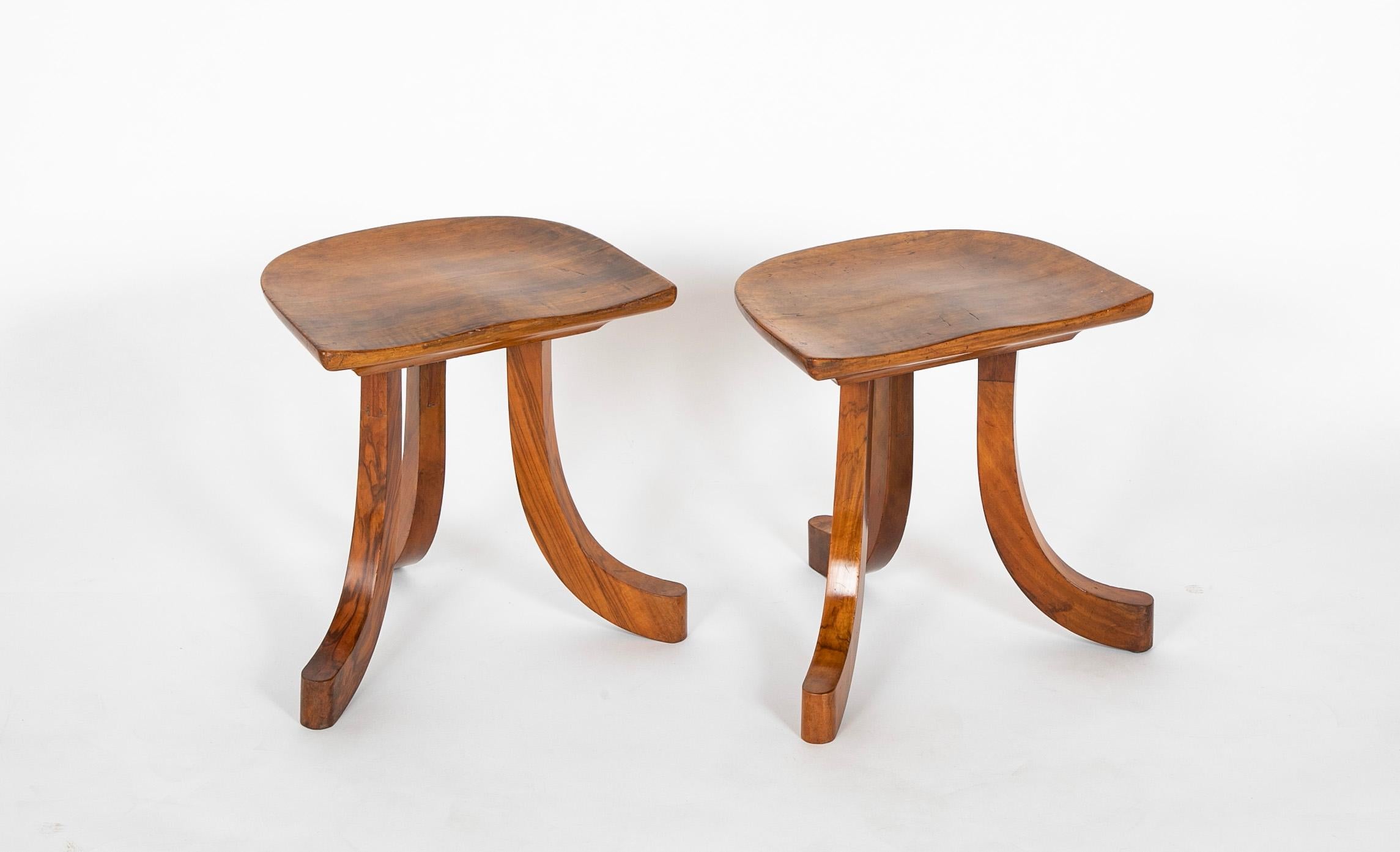 Pair of walnut tripod Thebes stools in the manner of Liberty & Co.  England.  Circa 1920.