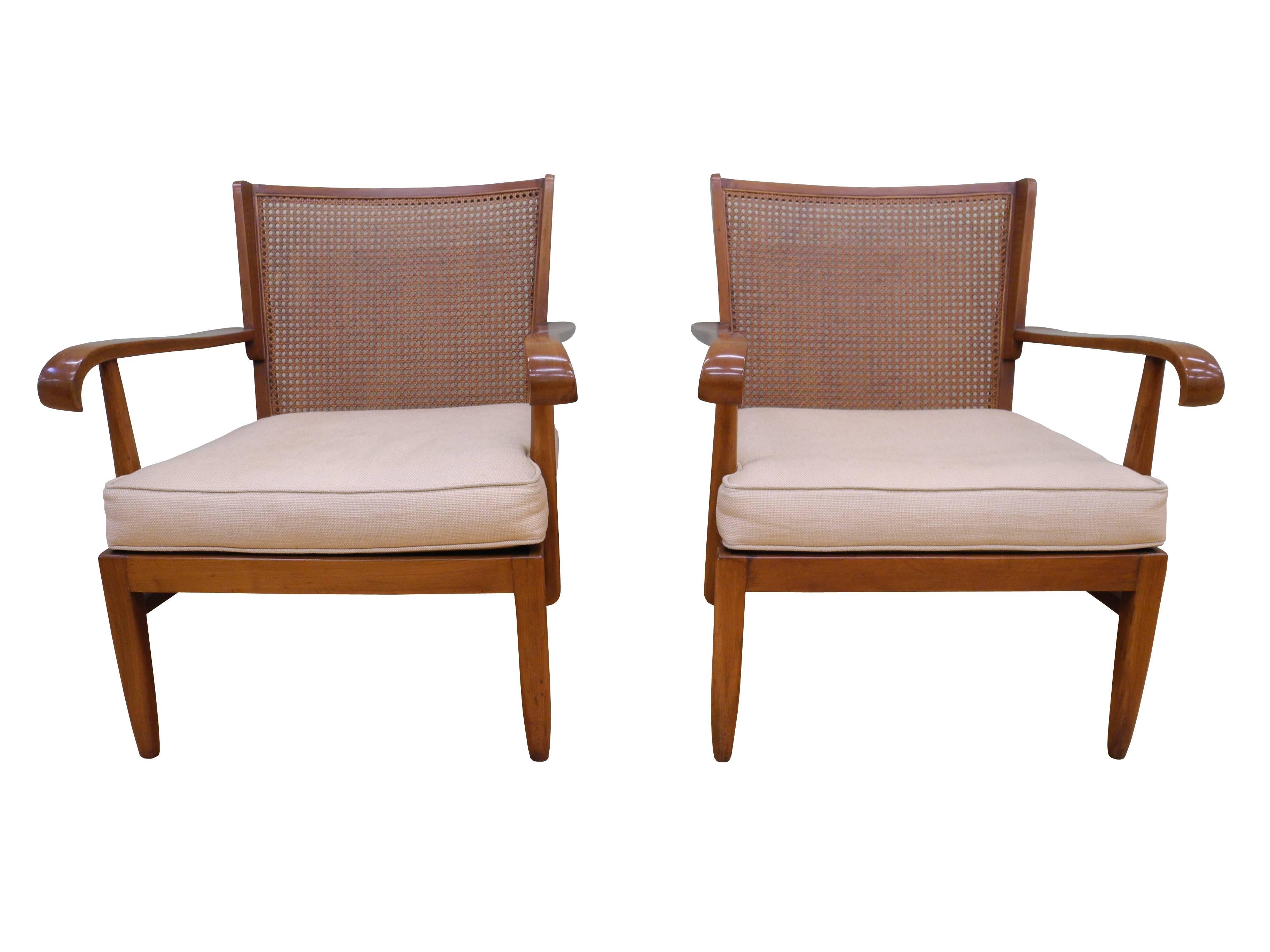These elegant 1930s cane and solid cherry armchairs are designed by Walter and Wilhelm Knoll for Knoll Antimott. The cushions have new upholstery and the cane has no damage.