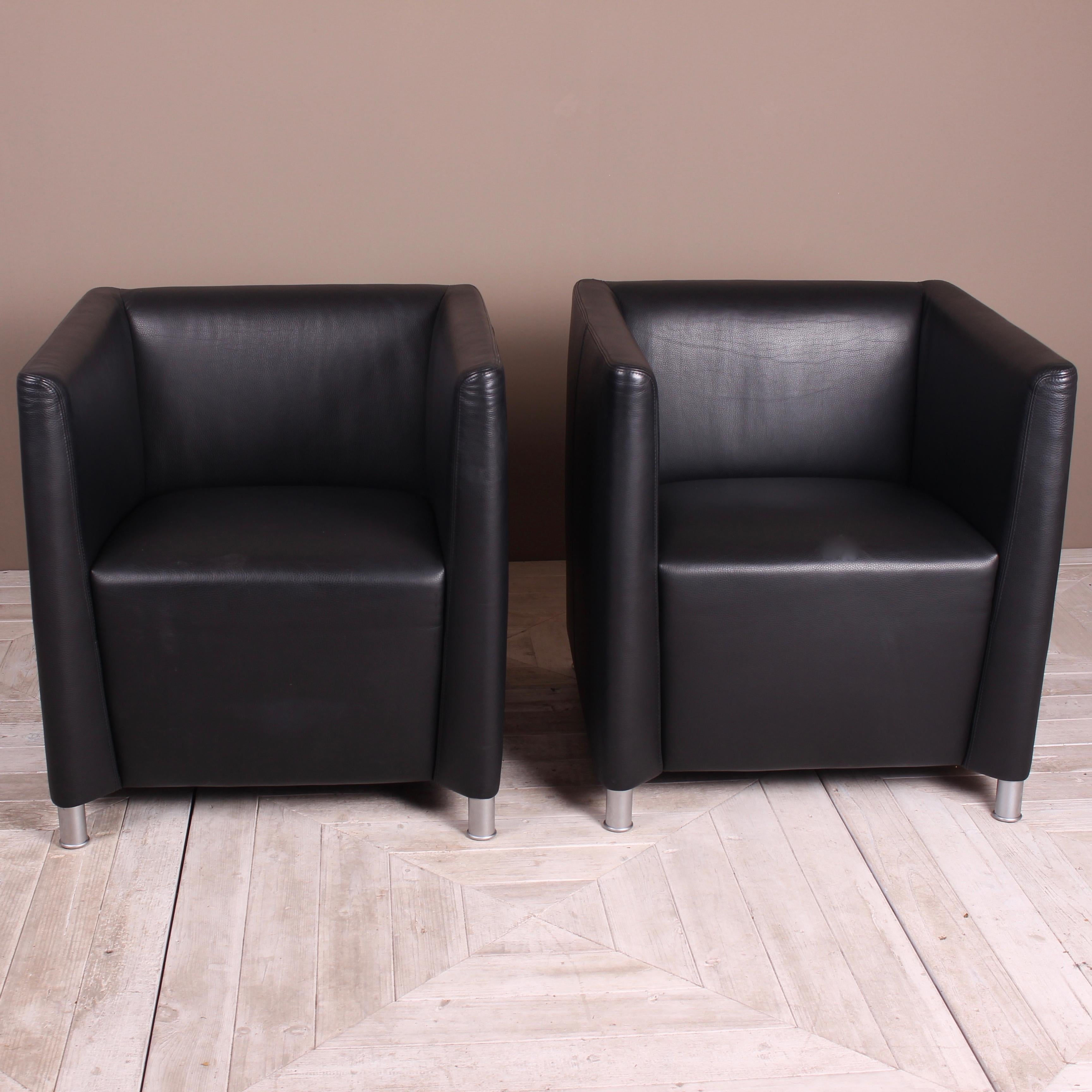 An attractive pair of Walter Knoll black leather tub lounge chairs. Of cubic form and standing on circular steel legs. Covered in a good thick quality leather.