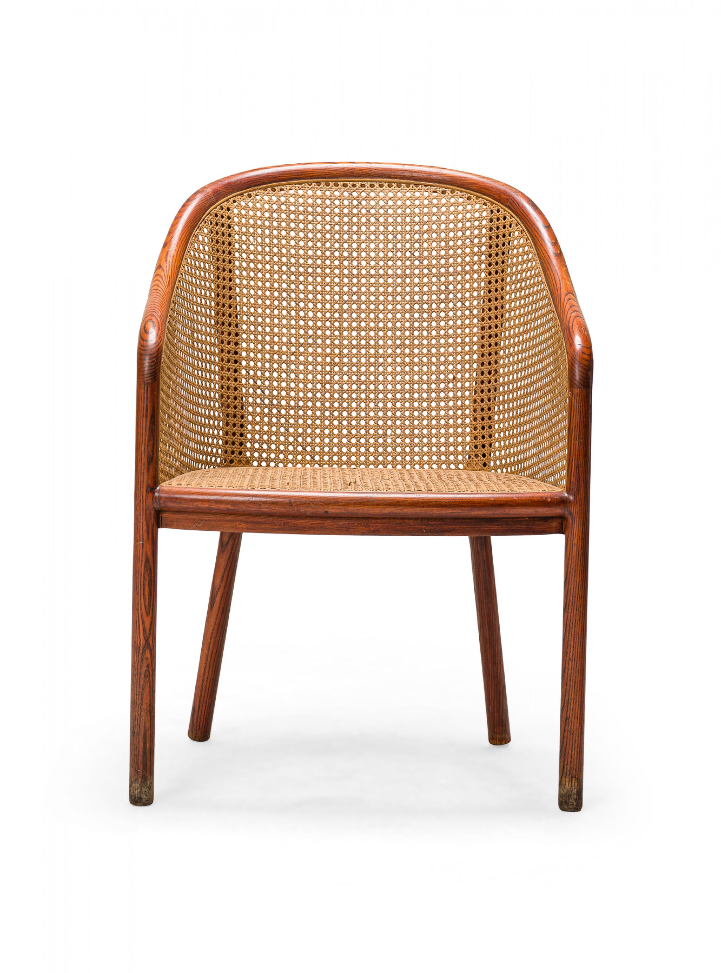 Pair of American Mid-Century armchairs with steam bent ash wood frames and caned backs, sides, and seats, resting on four dowel legs. (WARD BENNETT)(PRICED AS Pair)

Peeling and fraying of cane in several sections. The seat of one chair is sagging.