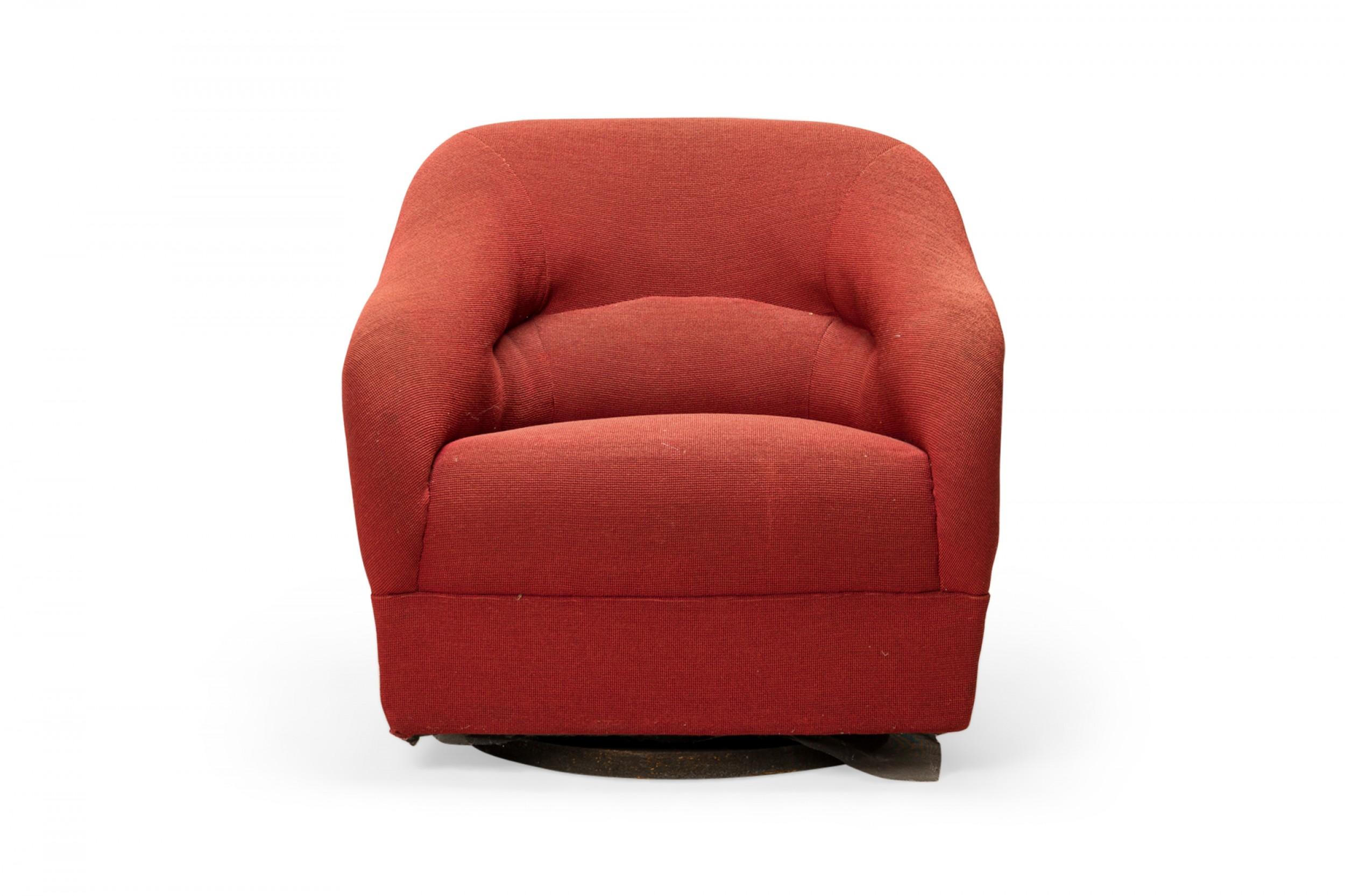 PAIR of American Mid-Century swivel lounge chairs with tub forms and plush rounded backs with a central channel, upholstered in light red fabric, resting on swivel plinth bases. (WARD BENNETT FOR BRICKEL)(PRICED AS PAIR).
 