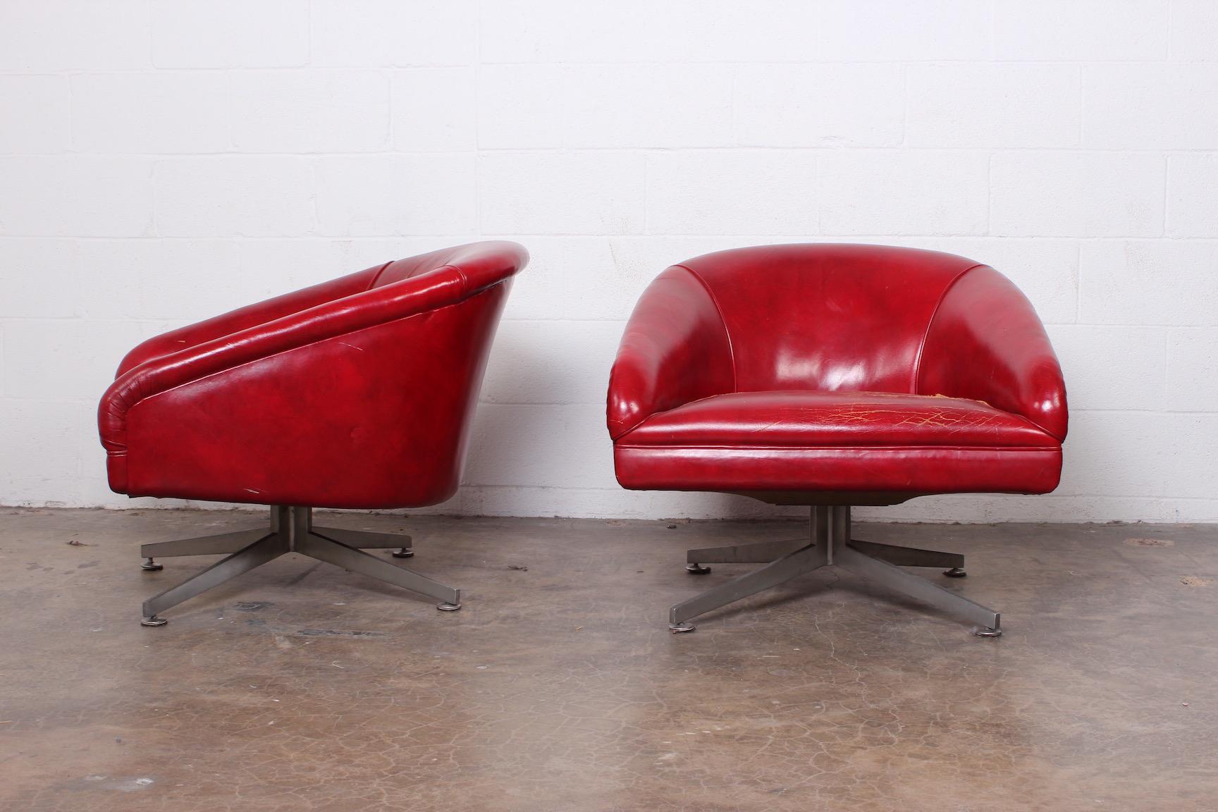 A pair of Ward Bennett lounge chairs with aluminum bases.