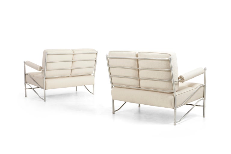 Warren McArthur sofas, model 915 anodized aluminum, machine pressed aluminum fittings. Reupholstered with Great Plains cotton-linen fabric. Padded bolster arms.
Measures: Outside arm height 25