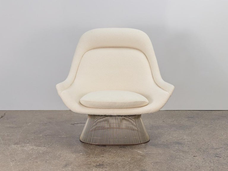 A pair of Model 1705 easy chairs with ottoman, designed by Warren Platner for Knoll. Zinc steel wire rods are bent and welded to form a graceful, sculptural Silhouette. A generously sized lounge chair, the comfortable seat is newly upholstered in