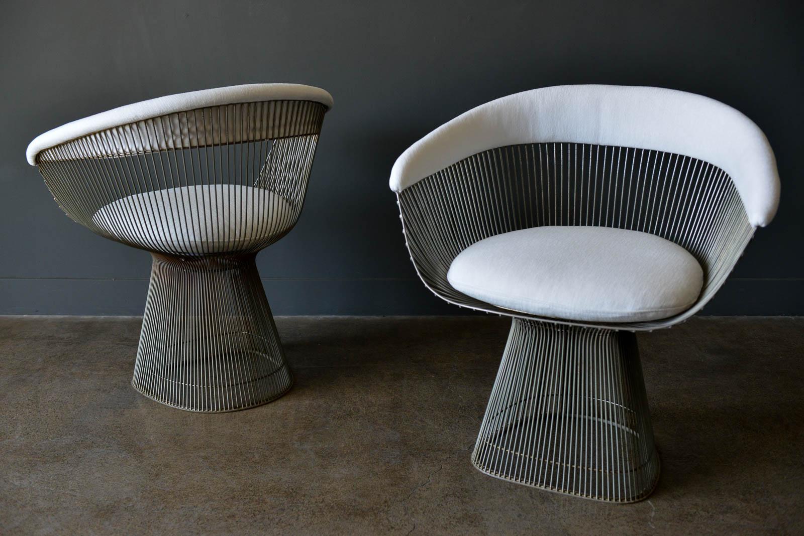 Pair of Warren Platner for Knoll Armchairs, ca. 1970. Nickel plated steel frames with newly upholstered cushions and backrest in beautiful ivory tweed. Classic and elegant design, these are original pieces with slight patina to the frames, but in